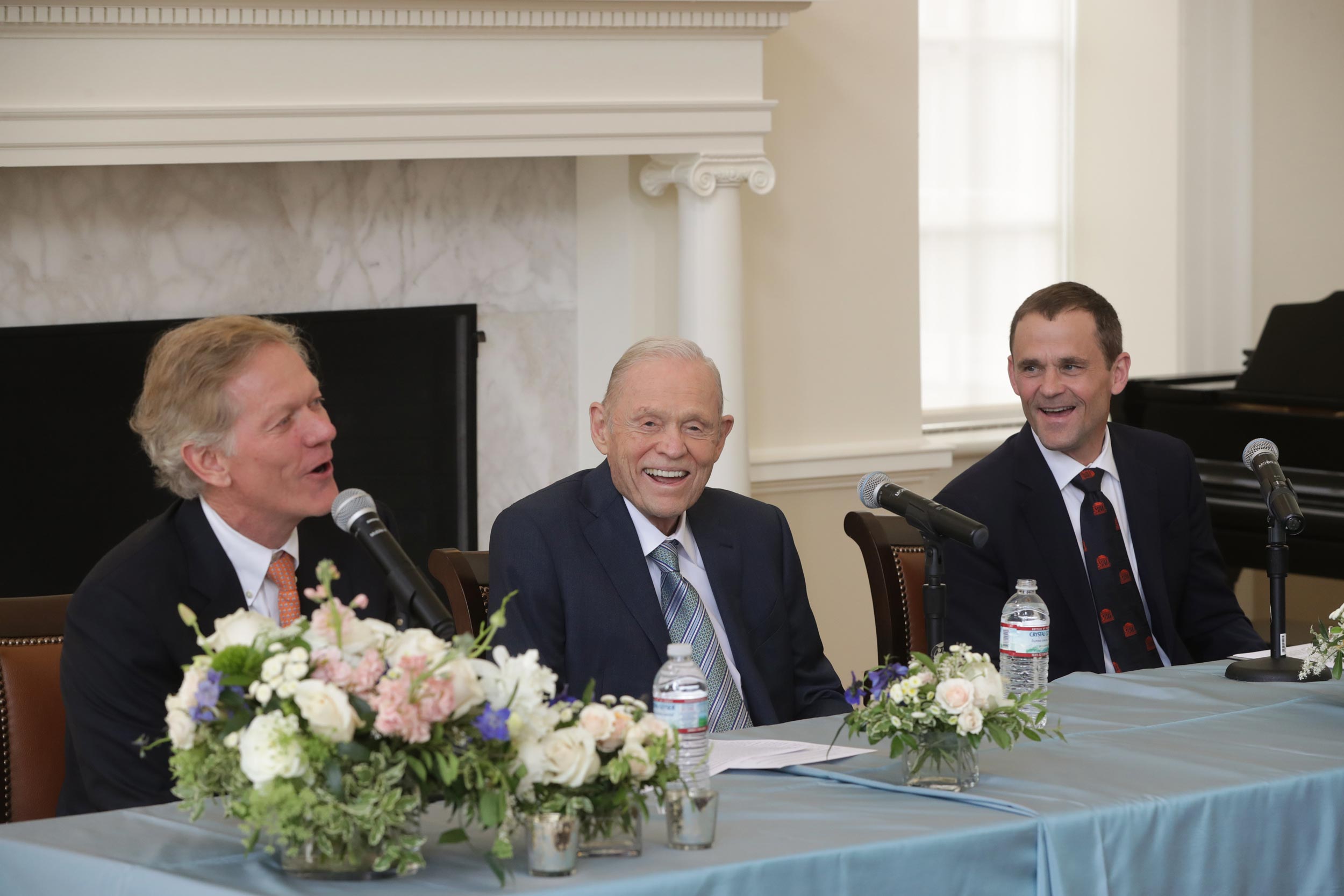 Scott Beardsley, left, Frank M. Sands Sr. and President Jim Ryan sit at a table talking and laughing