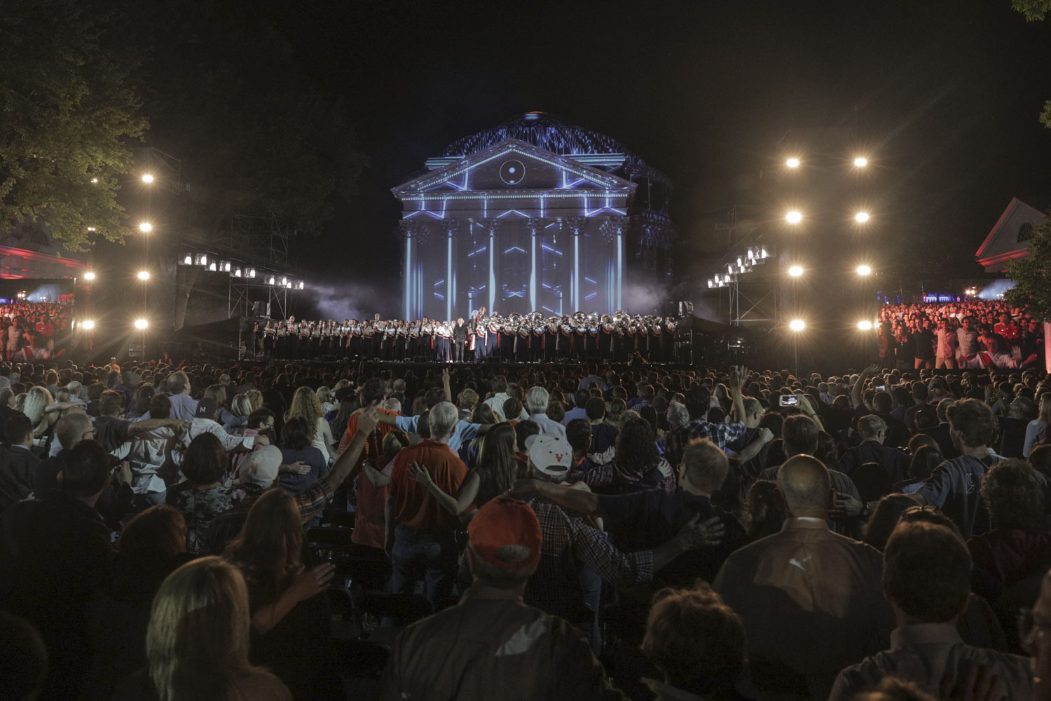 Crowd watching the orchestra stand after performing 