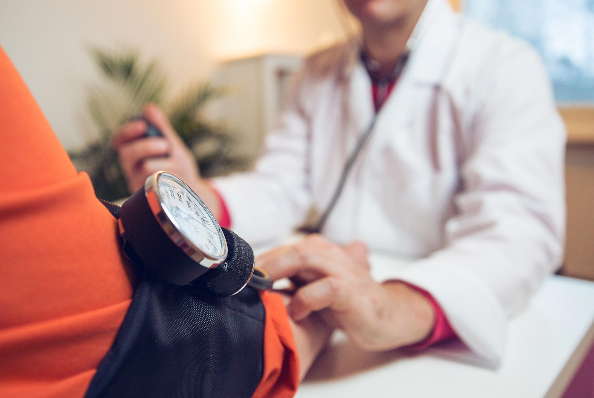 Healthcare professional taking a patients blood pressure