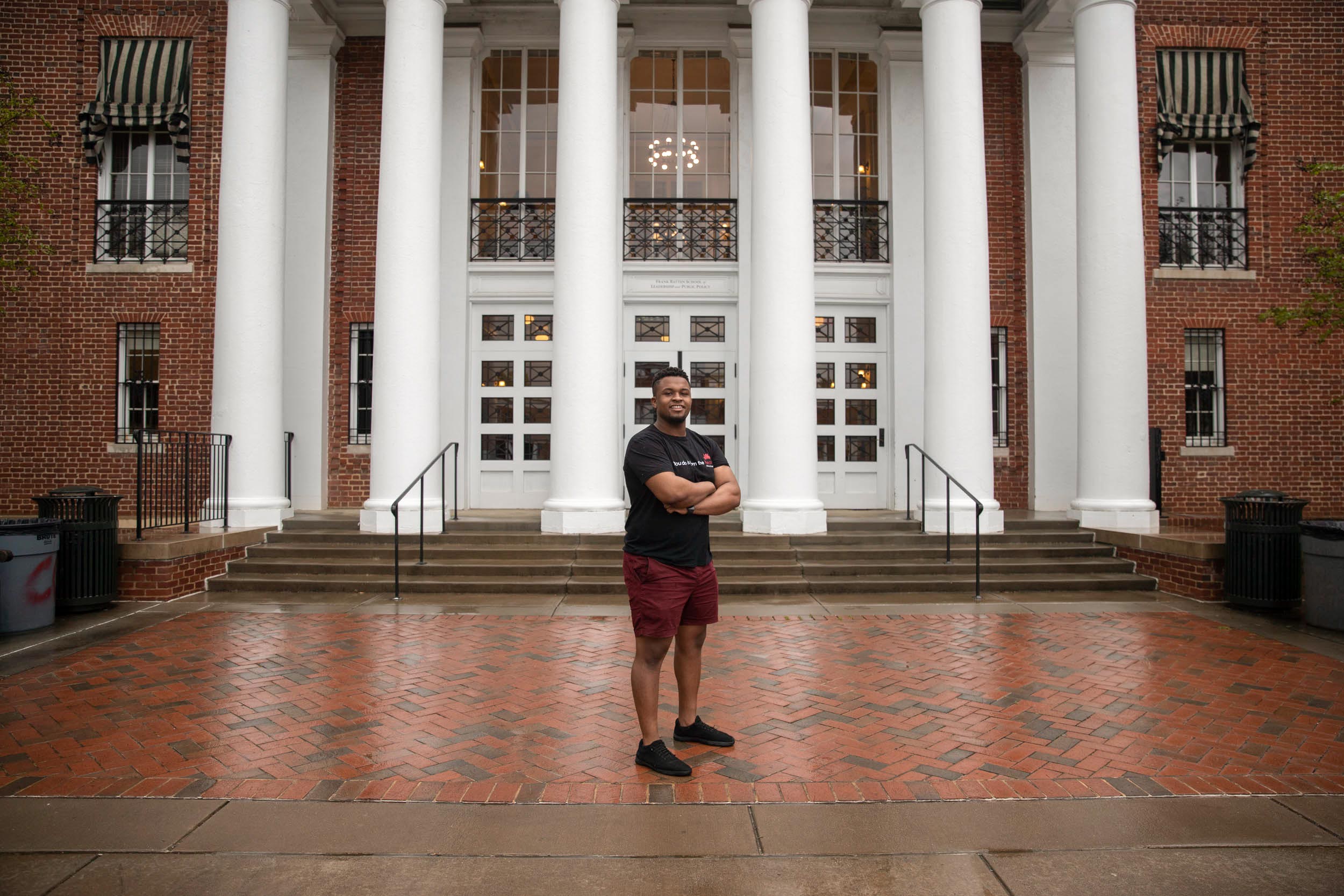 Duckettstanding in front of the Batten building with his arms crossed looking at the camera