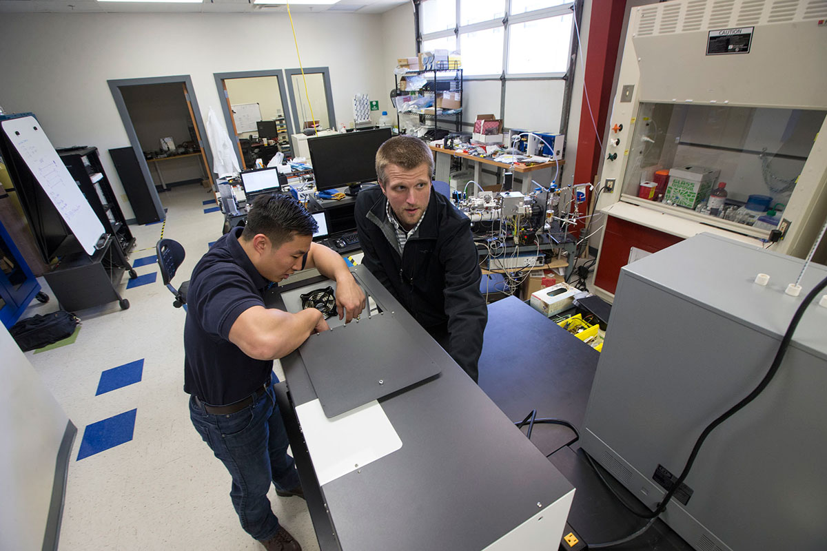 Albert Khim (left) works in the lab with Brent Harris, right.