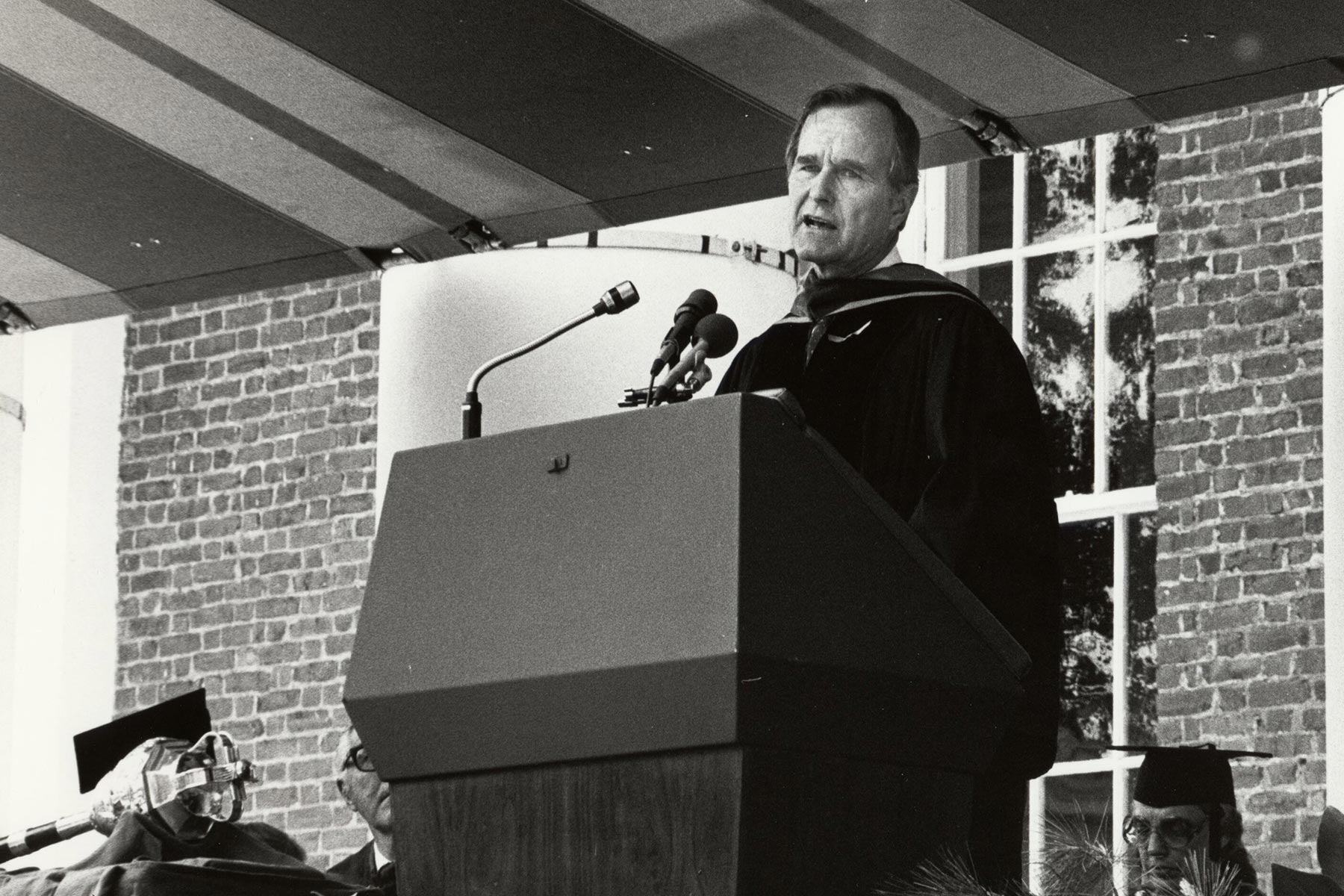 George H.W. Bush speaking at a podium during a UVA graduation