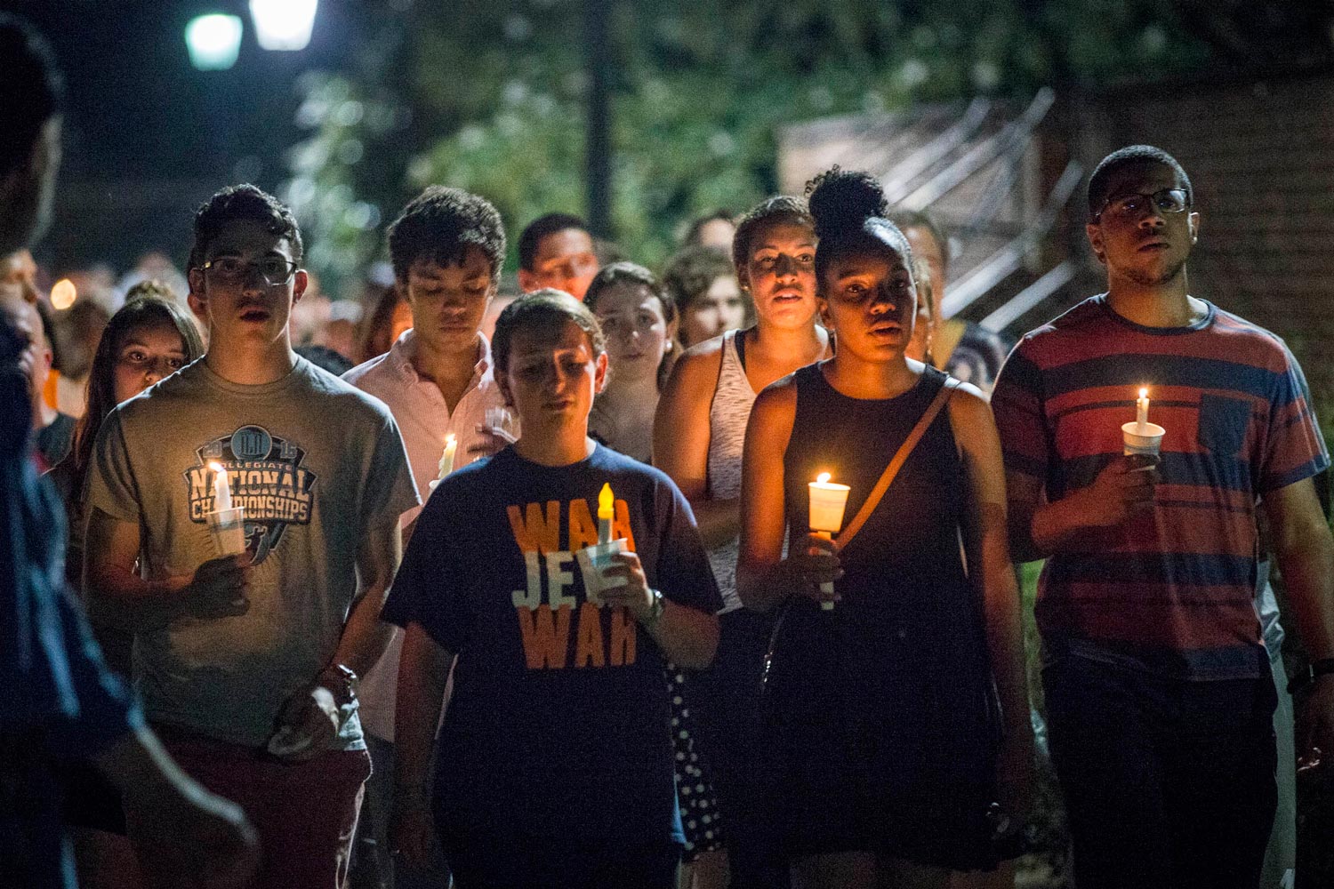 Students carrying candles to the Lawn