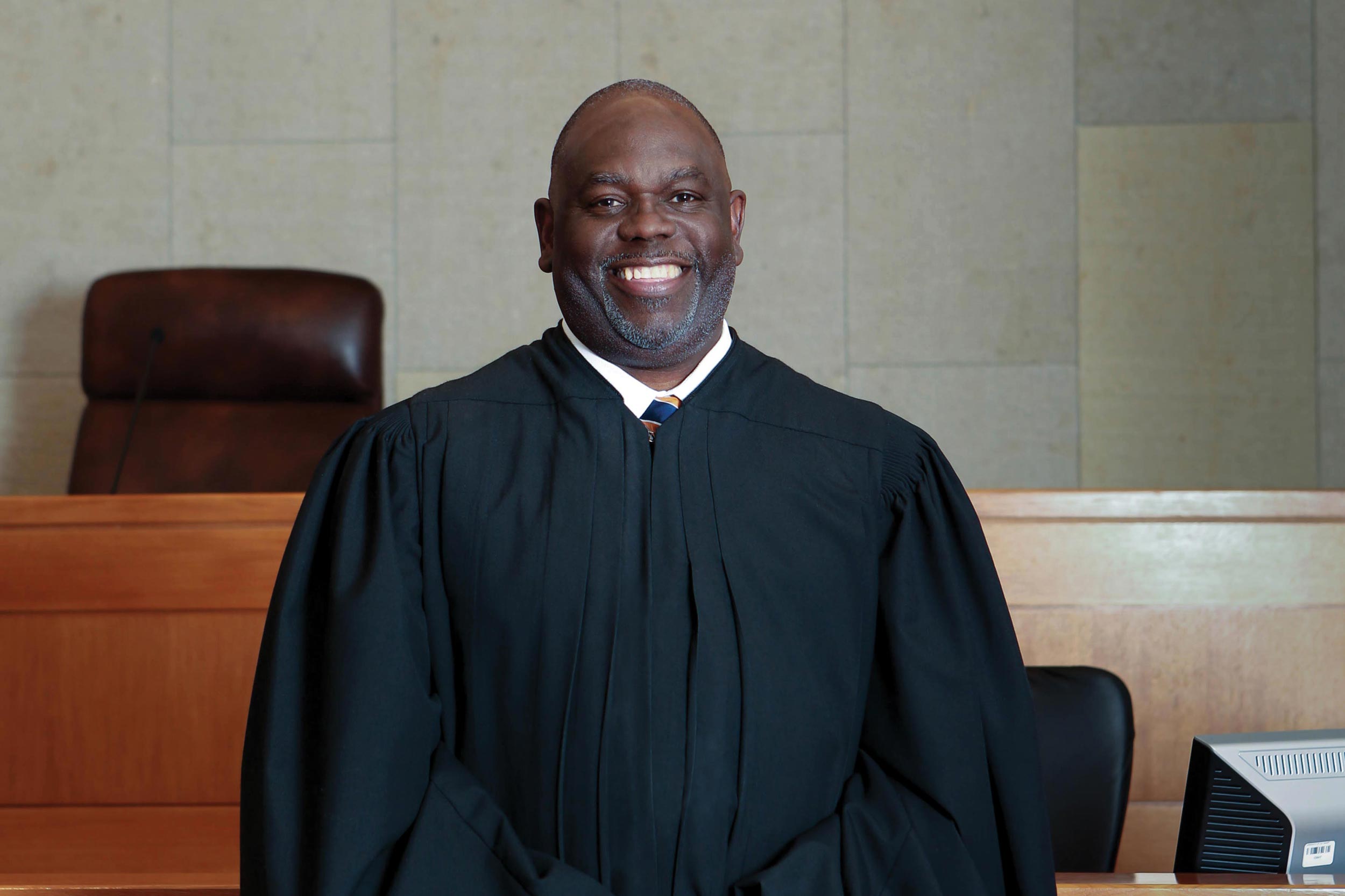 Judge Carlton W. Reeves stands in front of his bench