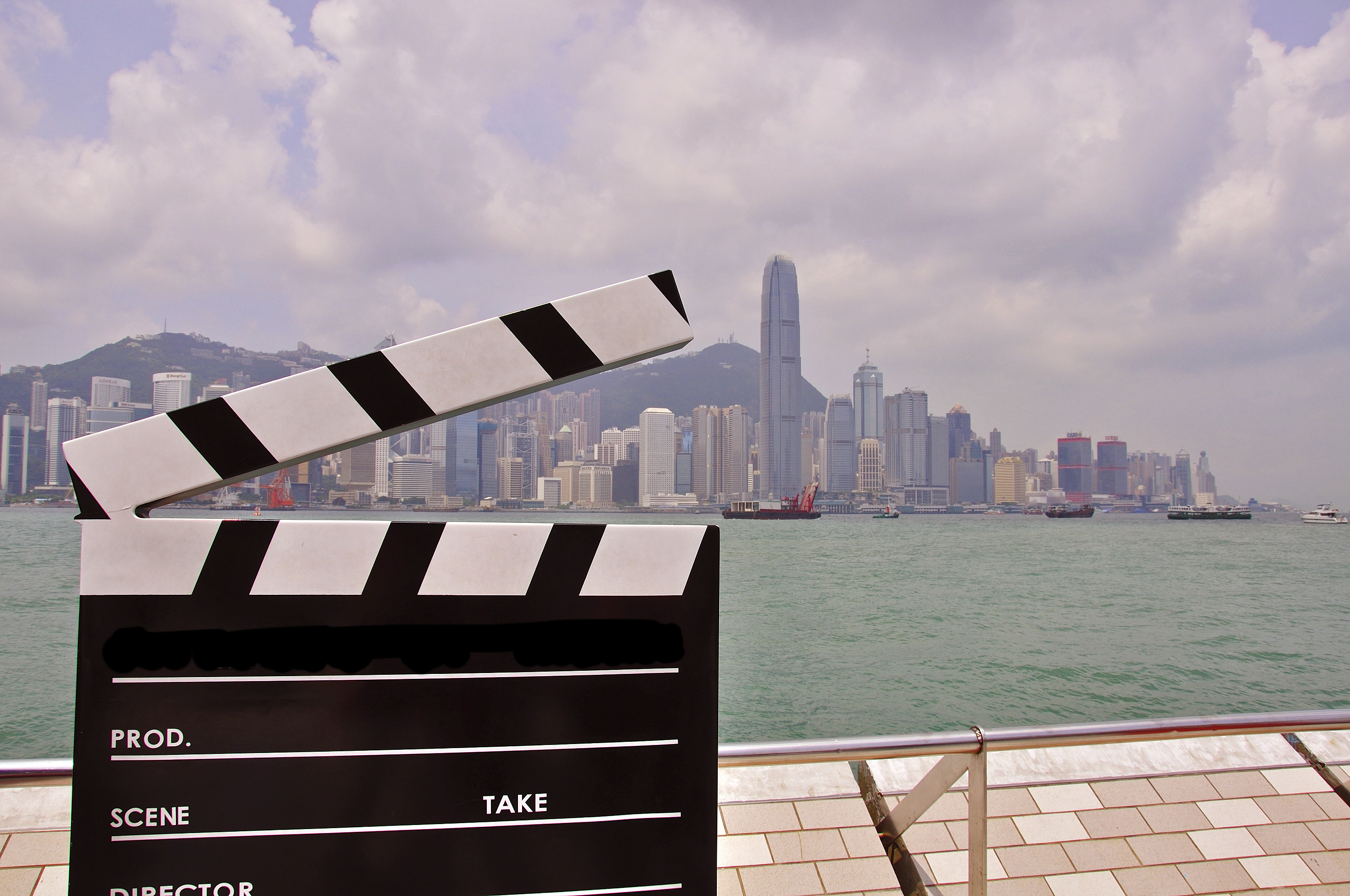 China city scape from across a sea and a black and white clapperboard 