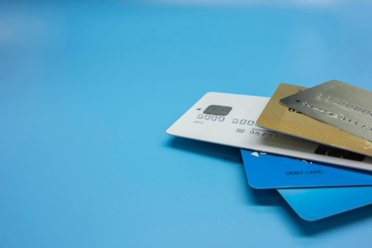 five credit cards stacked together on a sky blue background