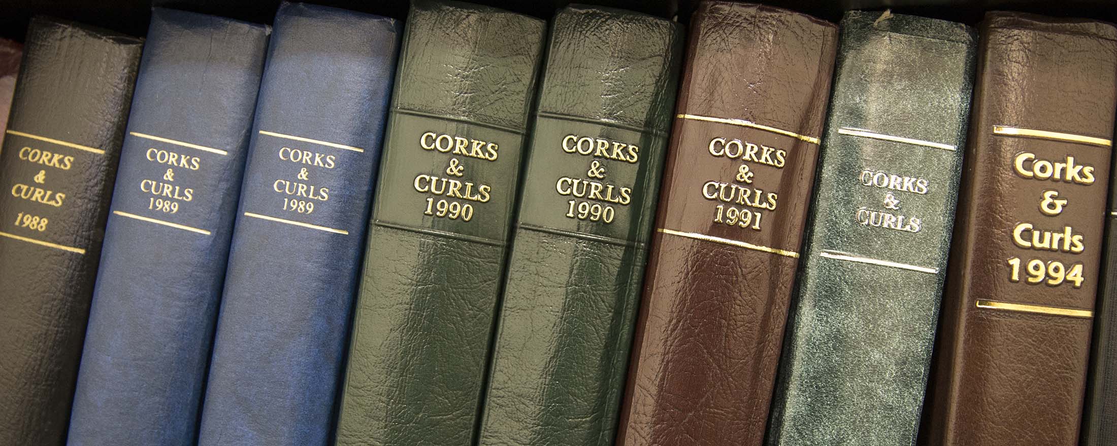 Yearly Corks & Curls books on a bookshelf