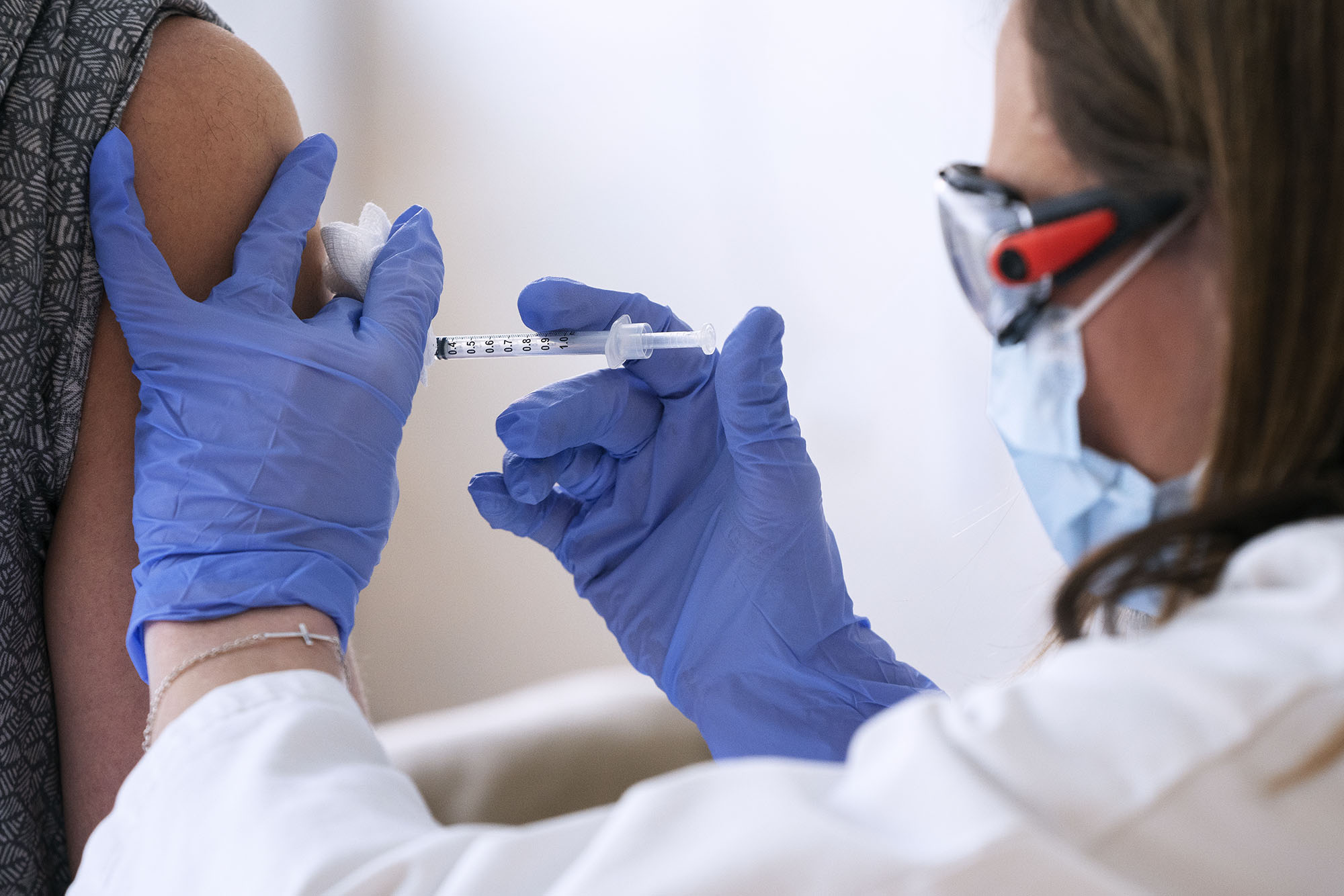 Healthcare professional giving a patient an injection