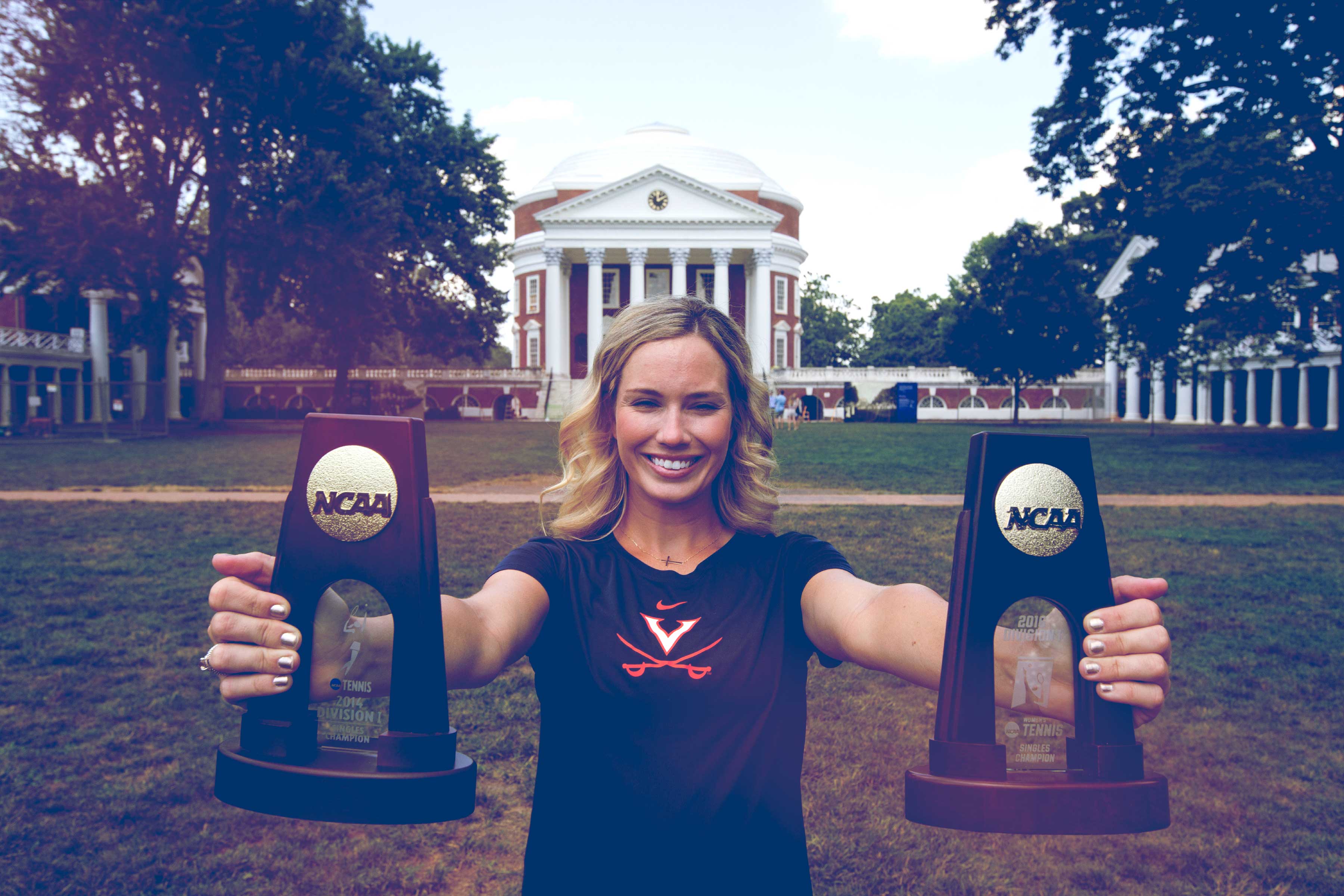 Danielle Collins holding her two NCAA trophies on the Lawn in front of the Rotunda