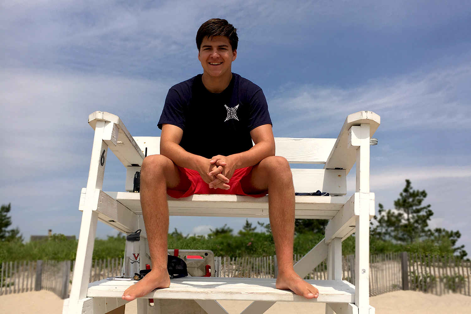 David Darling sitting in a lifeguard stand on a beach working