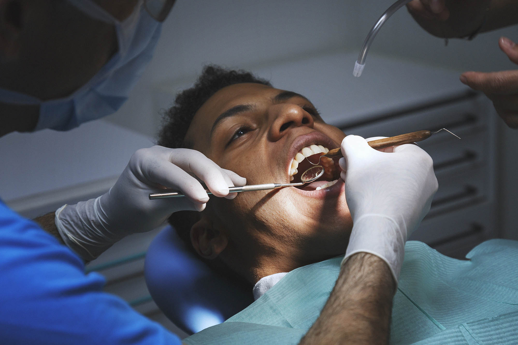 Man in Dentist Chair getting a routine dental exam