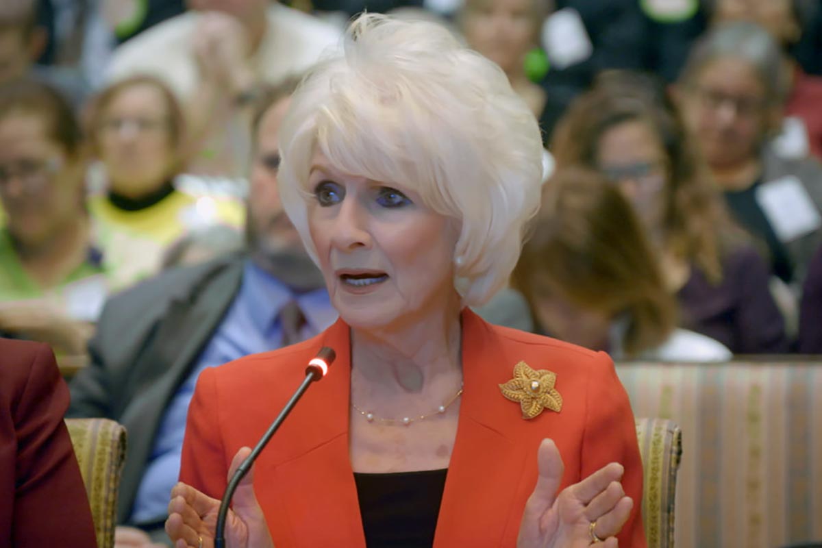 Diane Rehm sits at a table to testify to the Maryland Legislature 