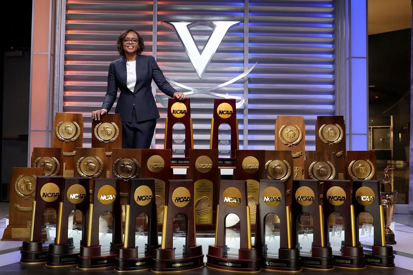 Carla Williams stands with all of UVA's trophys