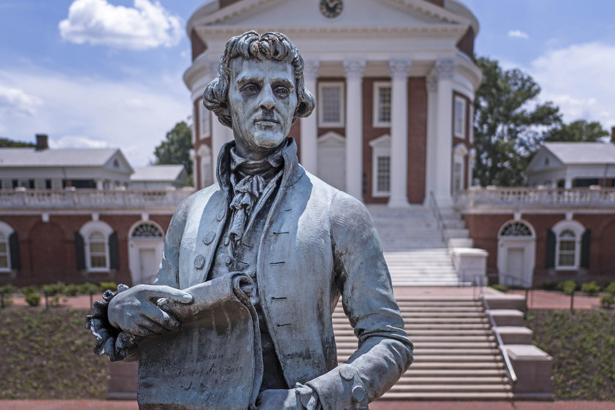 Up close view of the Thomas Jefferson Statue with the Rotunda behind him