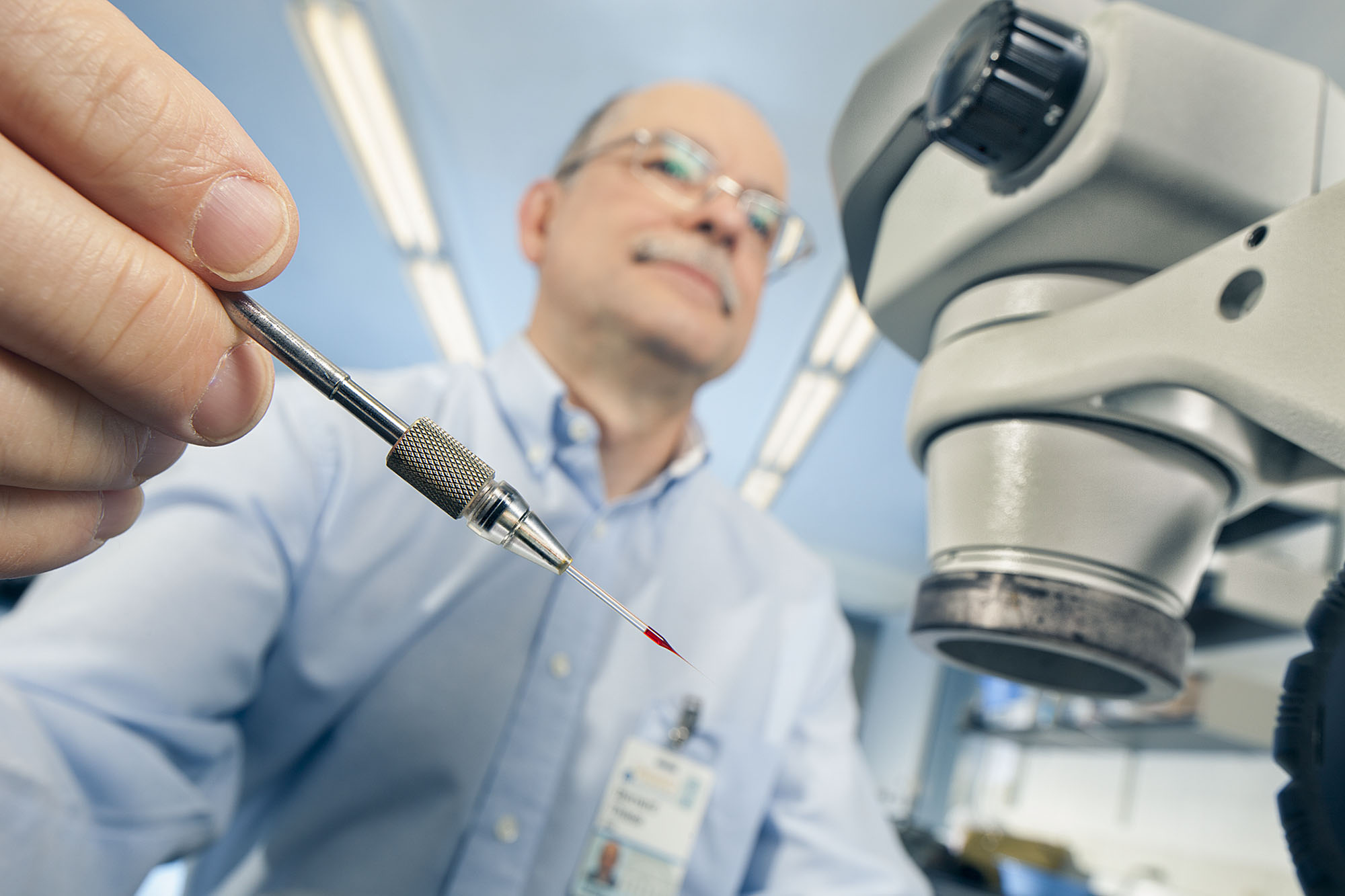 Bernard Thisse holding dye in a small pipet