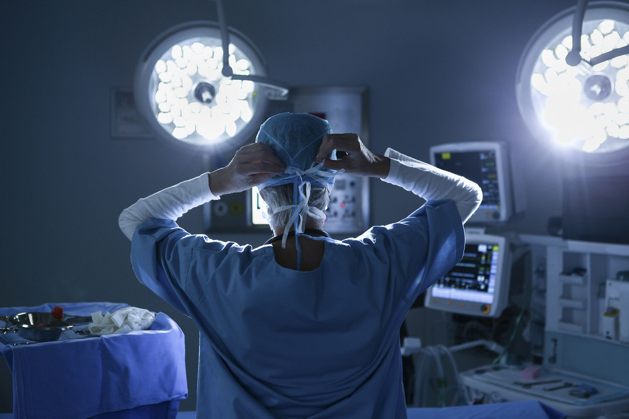 Medical Professional tying mask behind their head