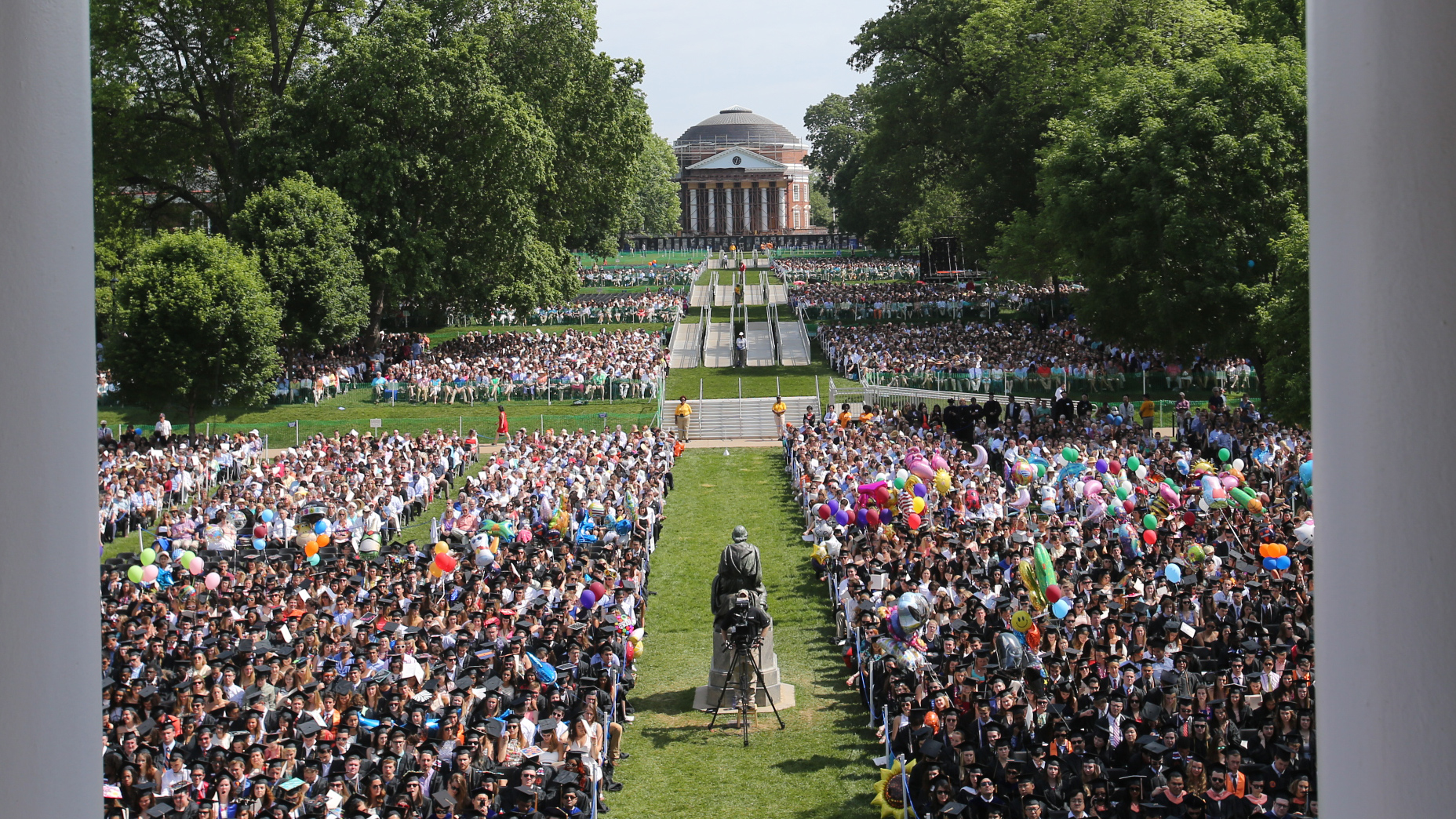 Aerial view of the lawn as graduates and their families sit in chairs