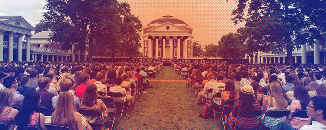 Students sitting in chairs on the lawn in front of the Rotunda listening to someone talking from a podium