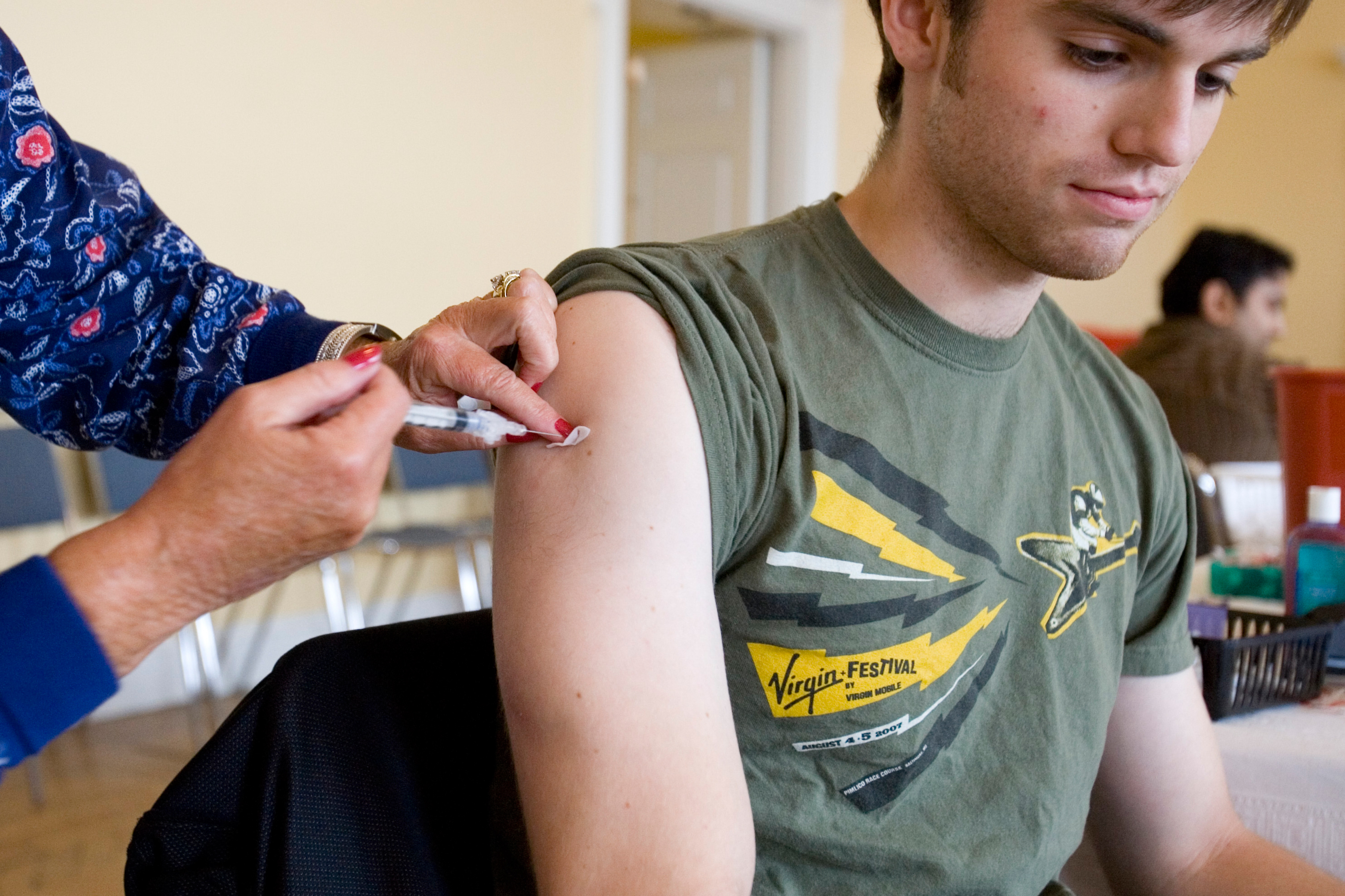 Student getting a vaccine from a nurse