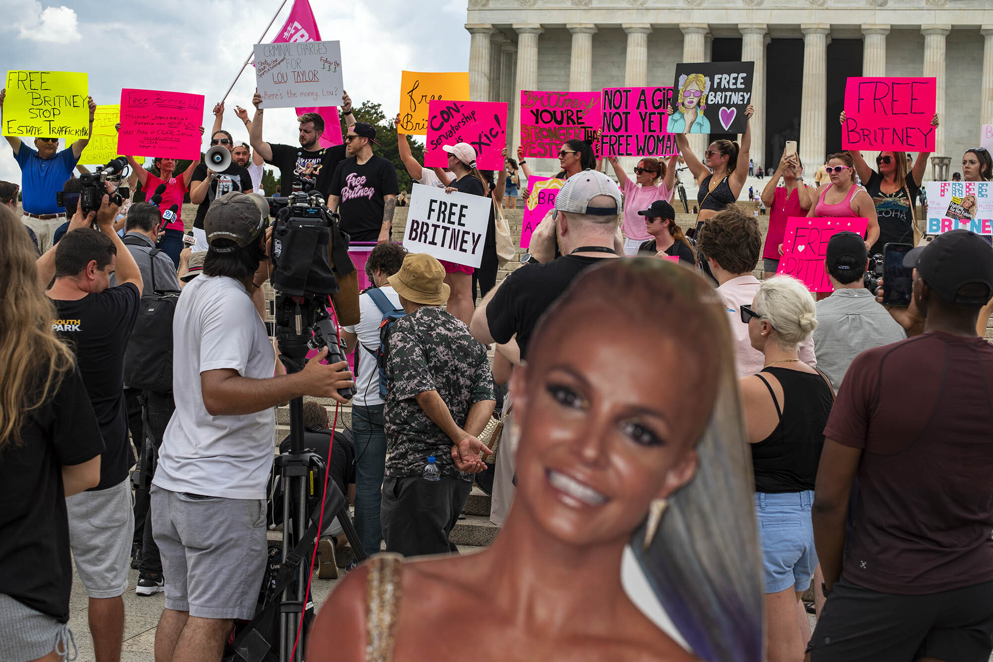 Group of people protesting holding signs that say free Britney