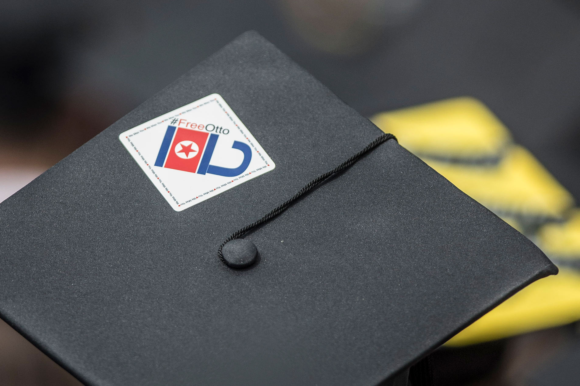 Graduation Cap with a sticker that says Free Otto
