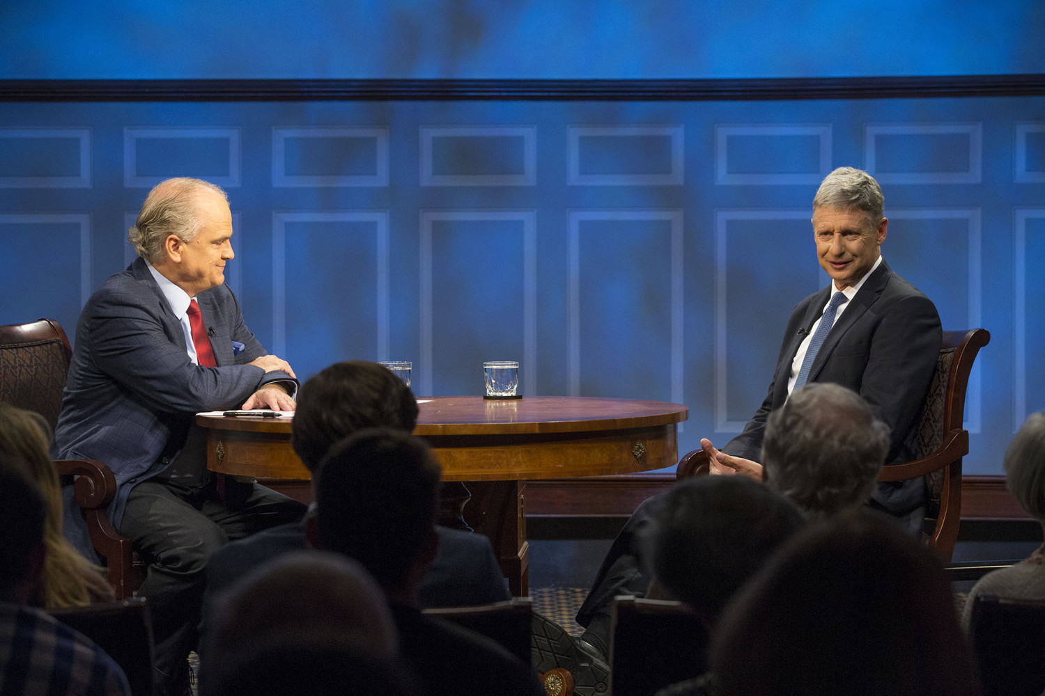 Gary Johnson, right, talking to an audience on stage