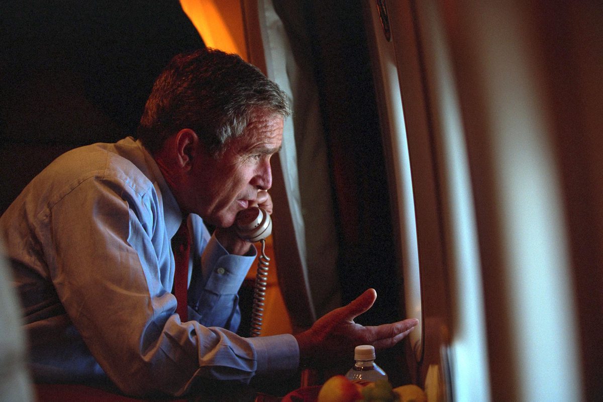 President George W. Bush talks on the phone 