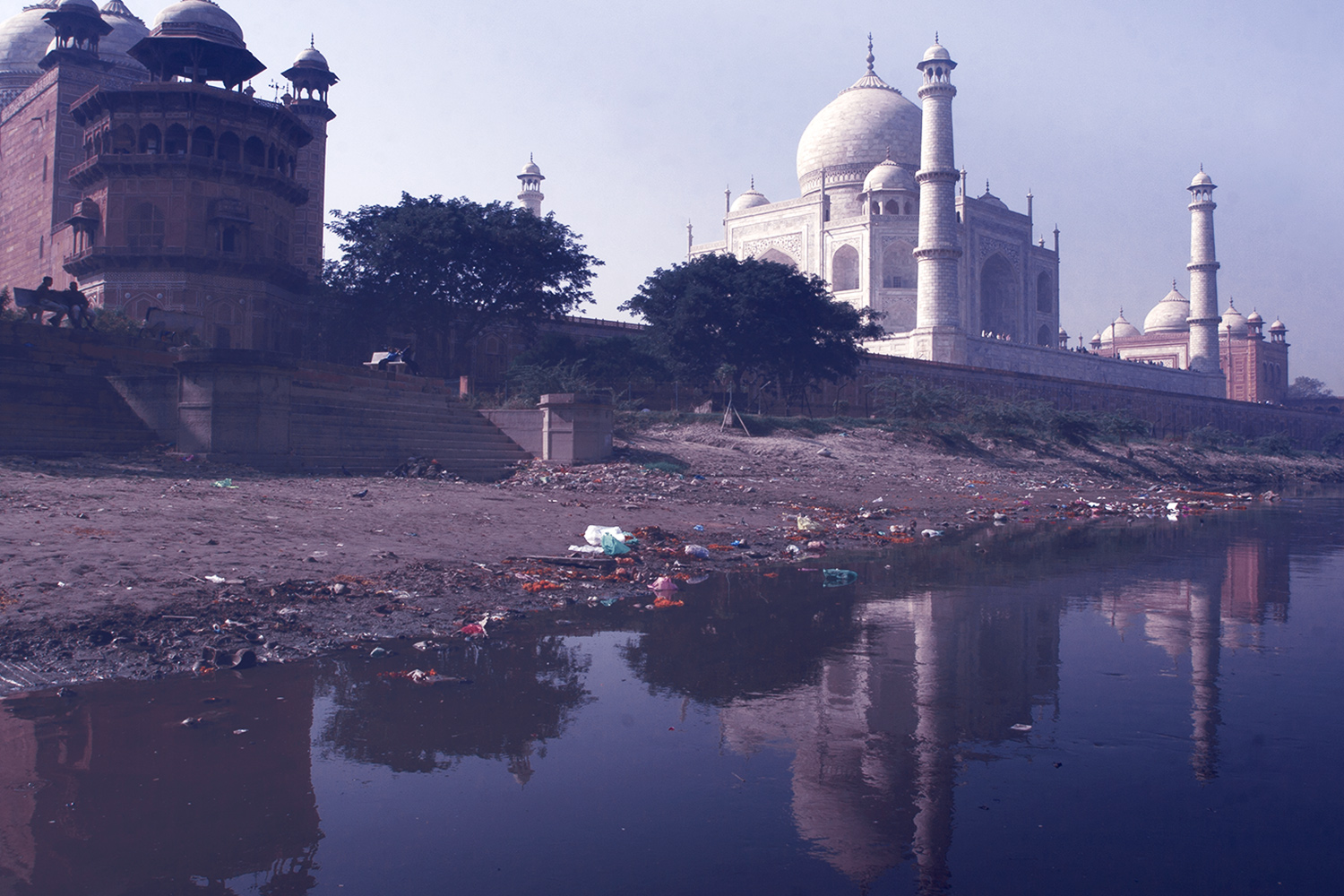 Taj Mahal next to dirty river water
