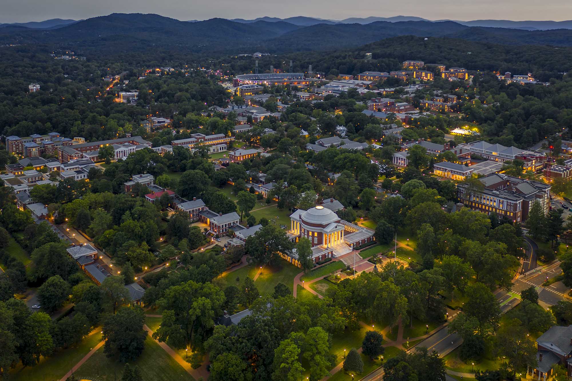 Aerial view of the Rotunda, the Lawn, and surrounding buildings at dusk