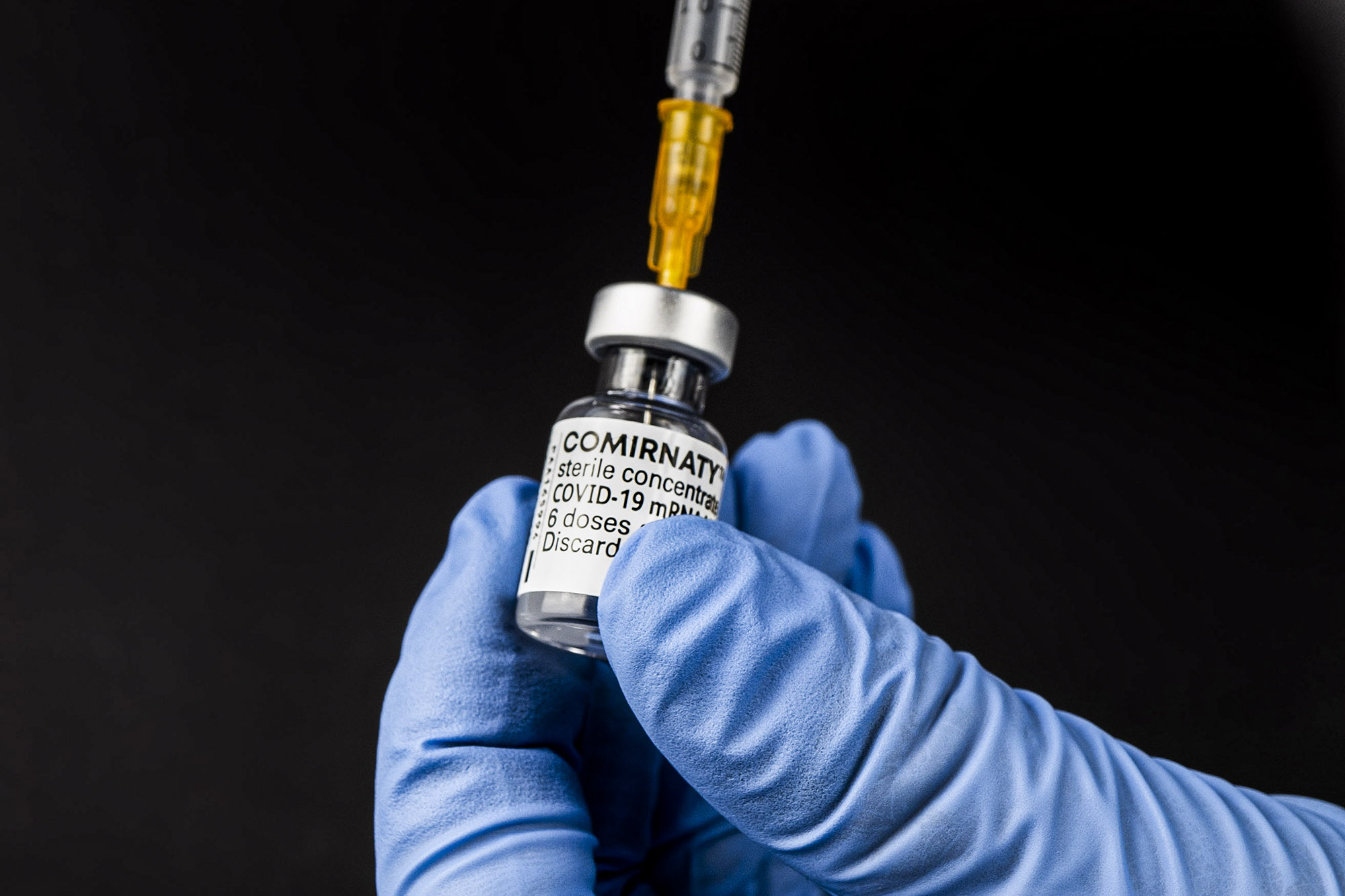 Syringe drawing up Covid-19 vaccine