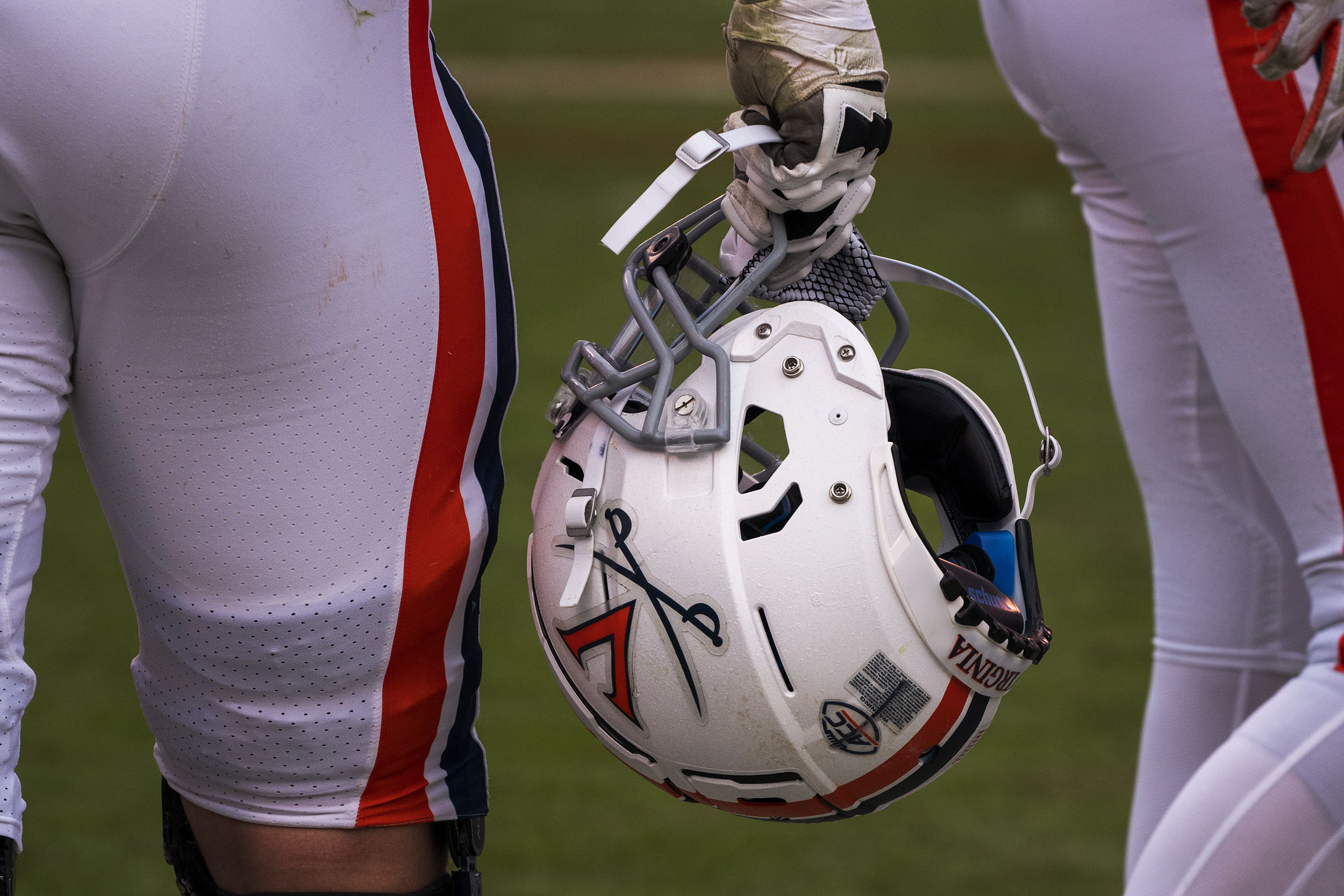 UVA Football player holds helmet