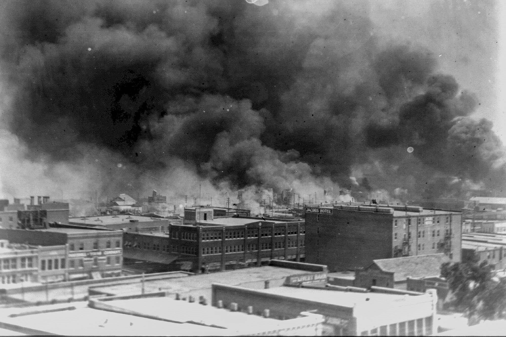 Black and White photo of smoke billowing over the city of Tulsa Oklahoma