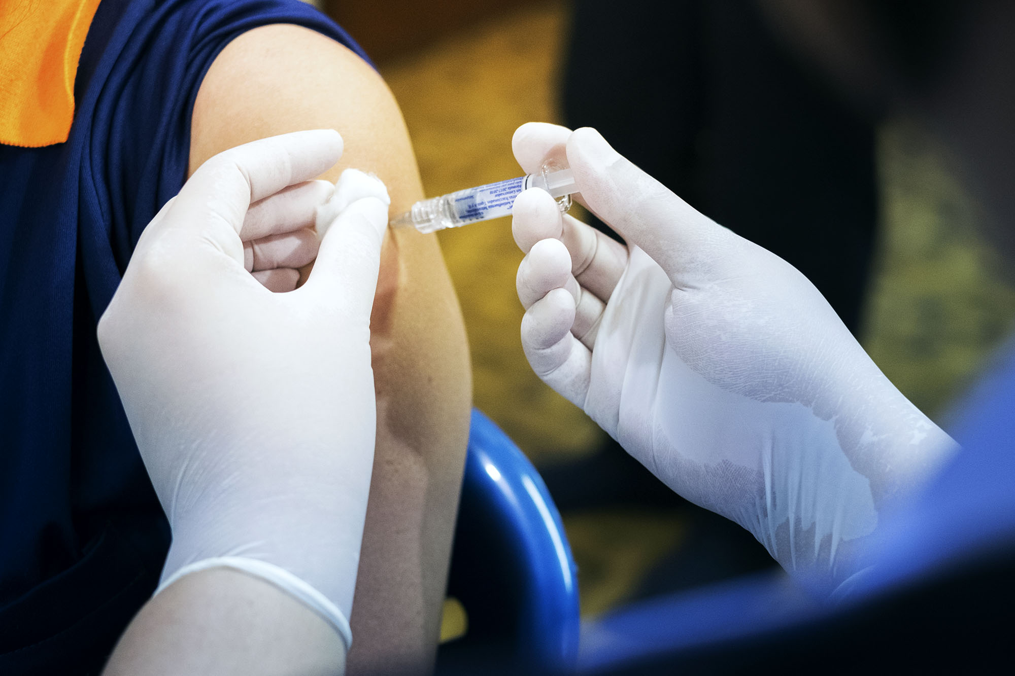 Healthcare professional giving a patient an injection