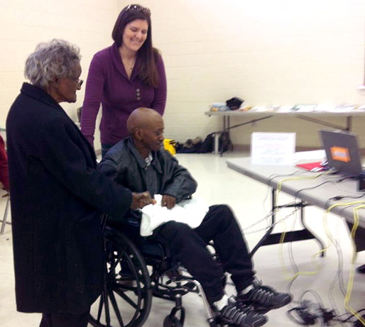 Alexandra Meador pushes Bennett Barbour in a wheelchair at the voting polls