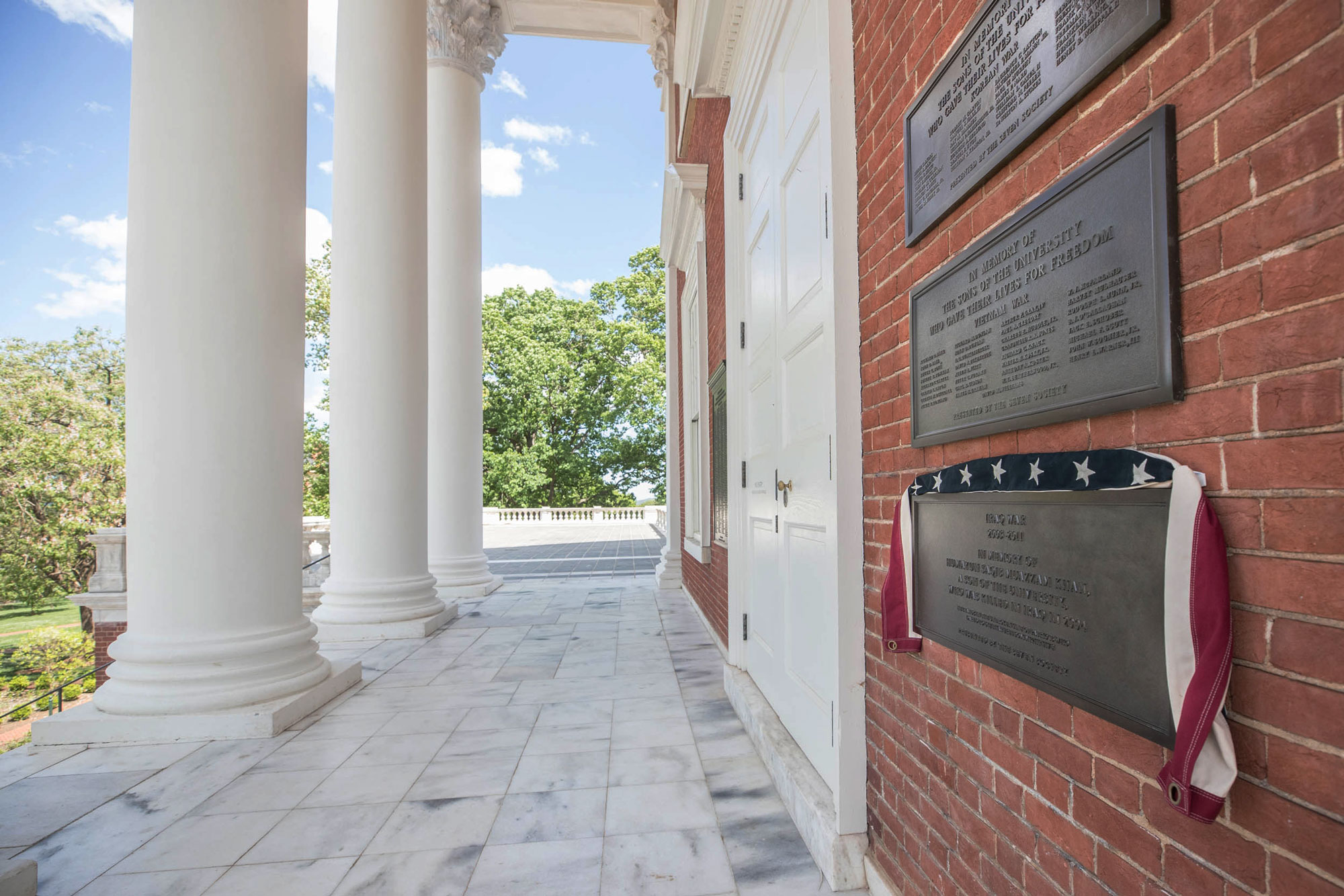 A new plaque mounted on the north wall of the Rotunda honors Capt. Humayun Khan, with an American Flag draped over it