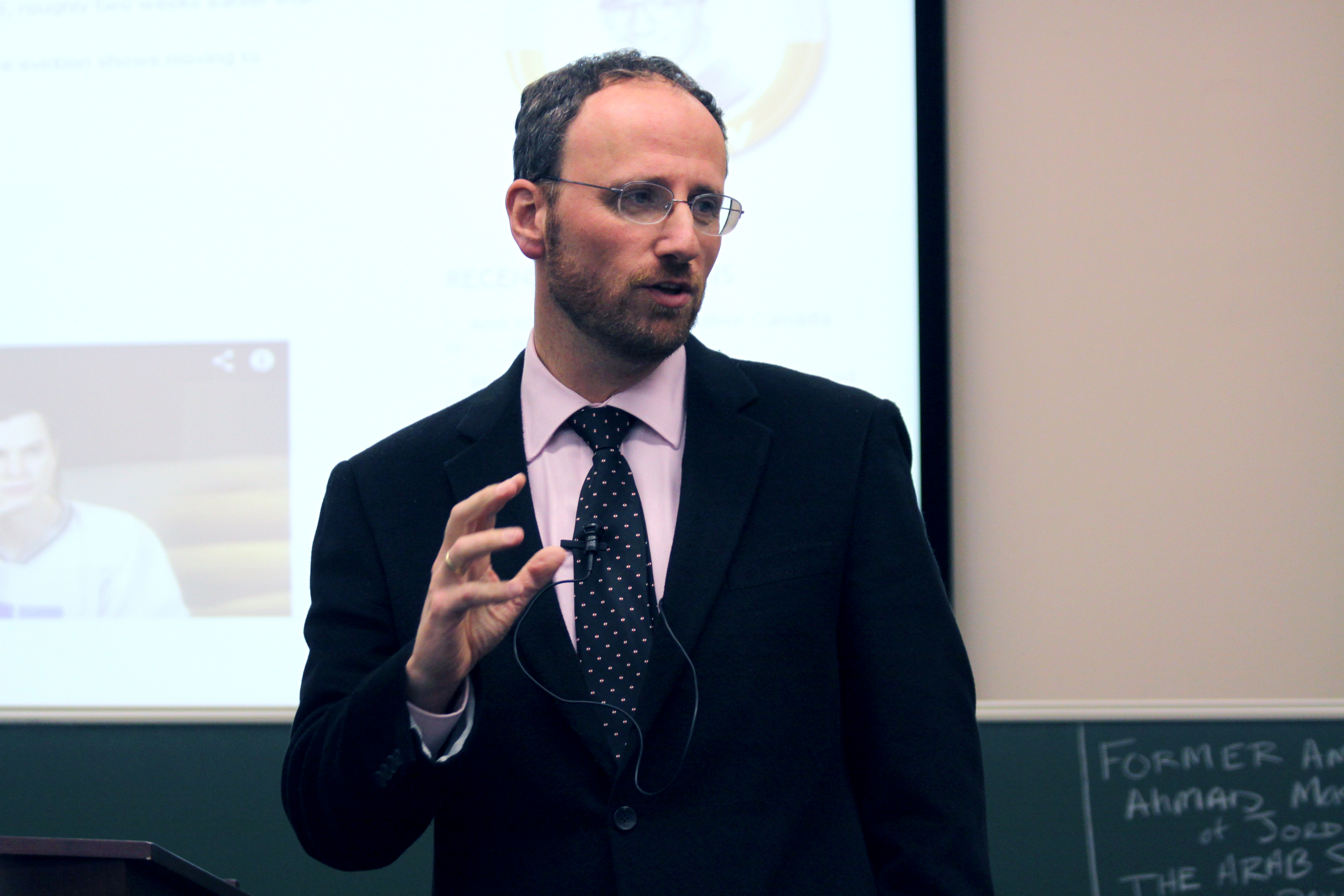 Dr. Gil Siegal speaking from a podium