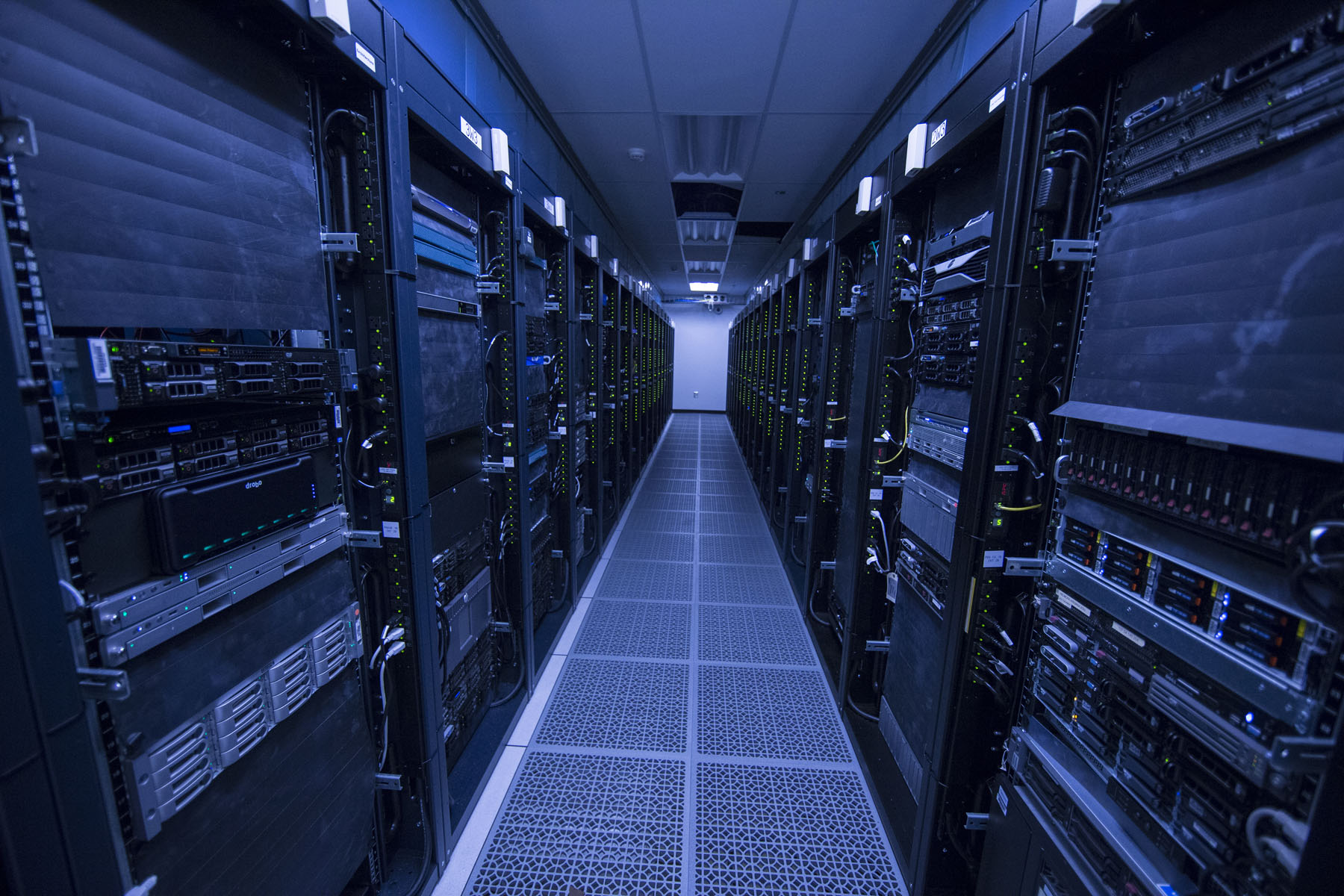 Dark room full of servers in shelves