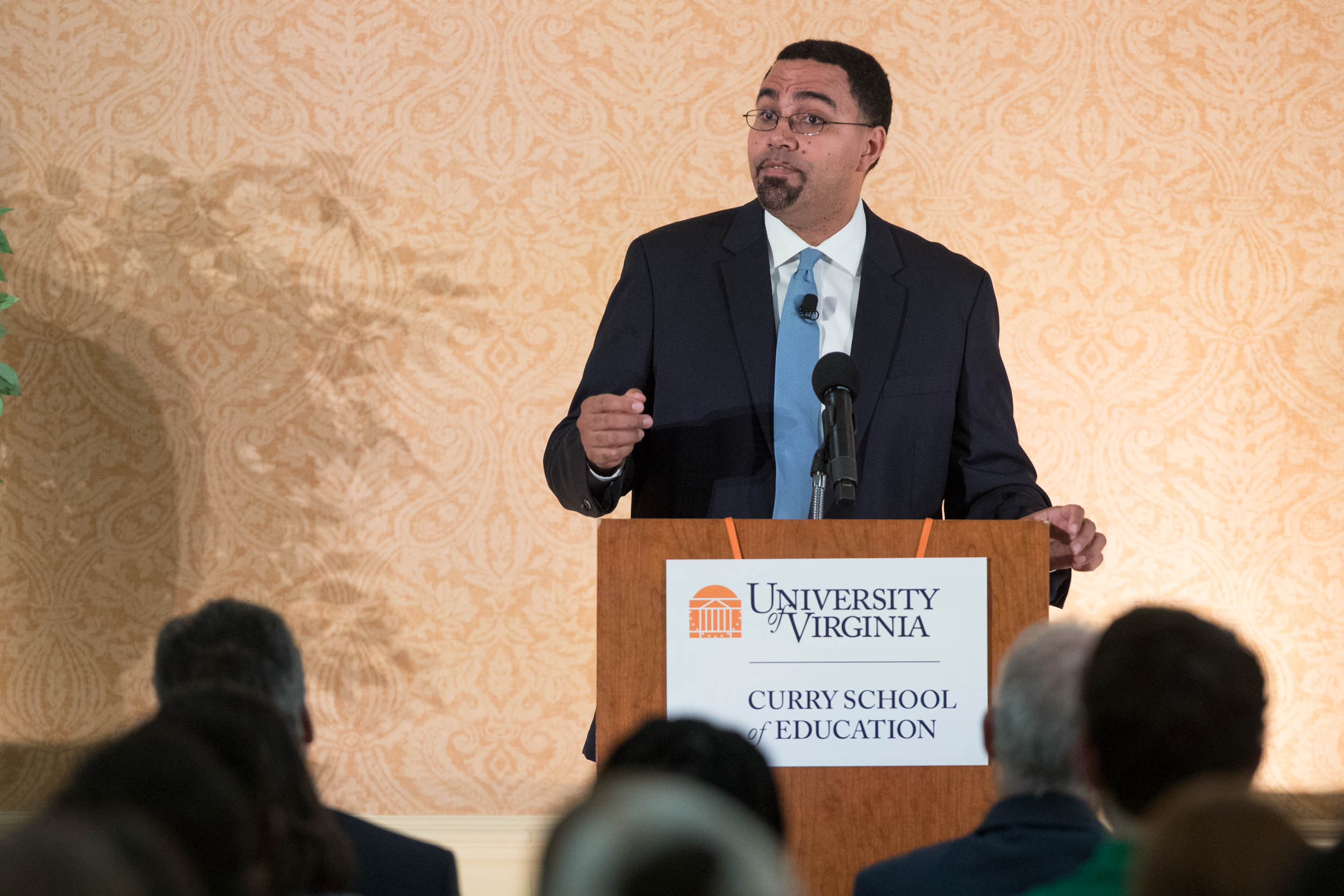 U.S. Secretary of Education John B. King Jr. speaking from a podium to a crowd