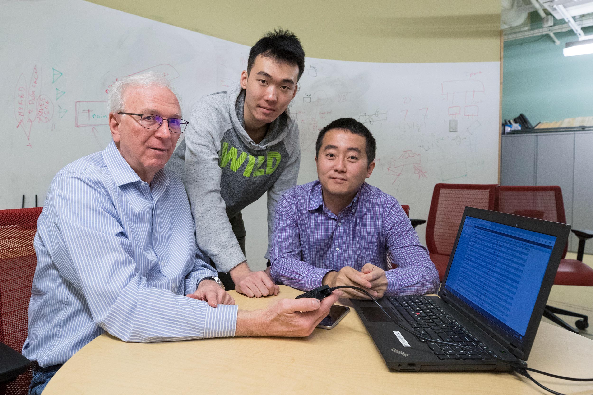 Computer scientists Jack Stankovic, left, Nan Wang, center, and Hongning Wang are developing the system.