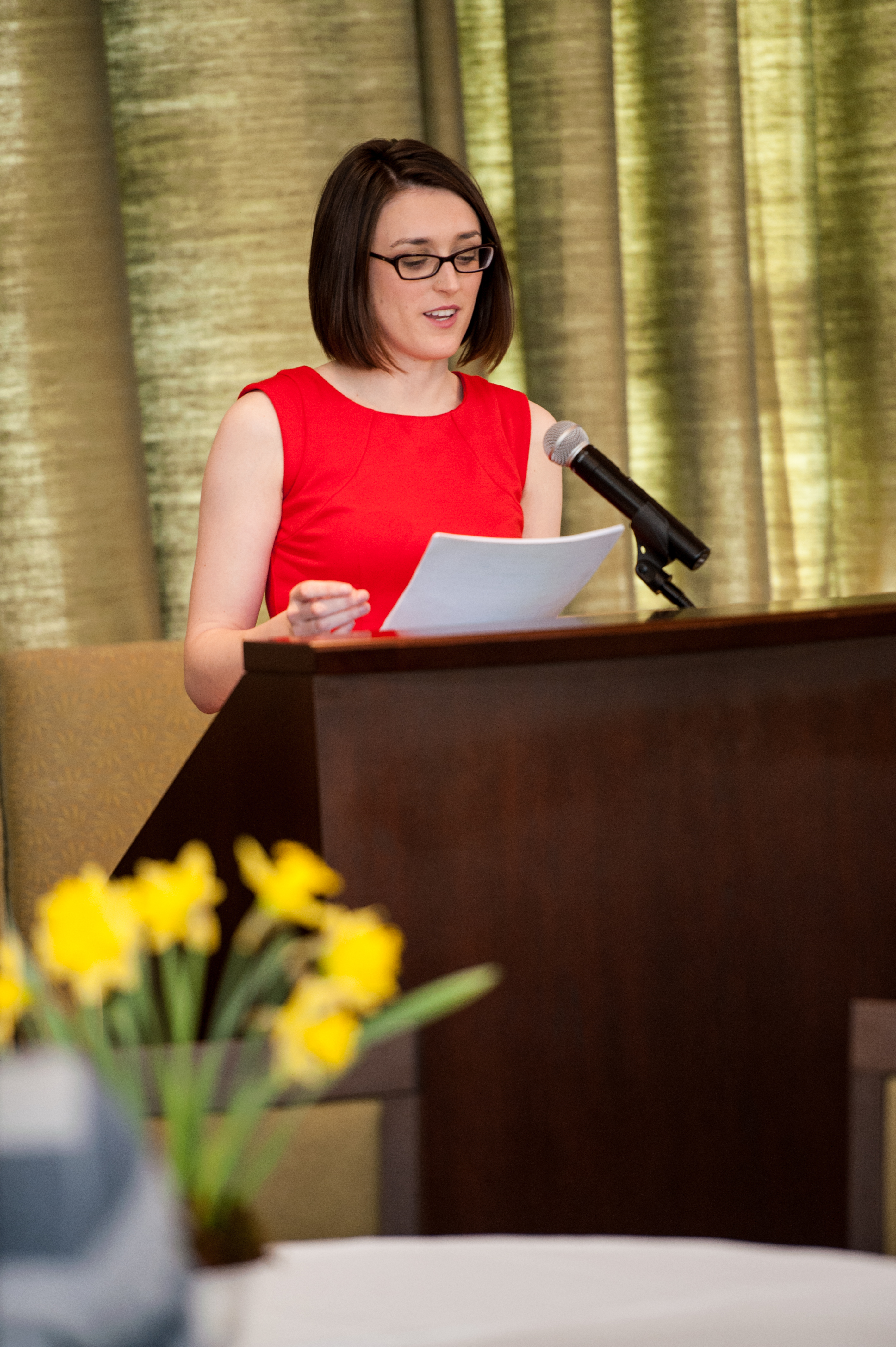 Sarah O'Halloran speaking at a podium