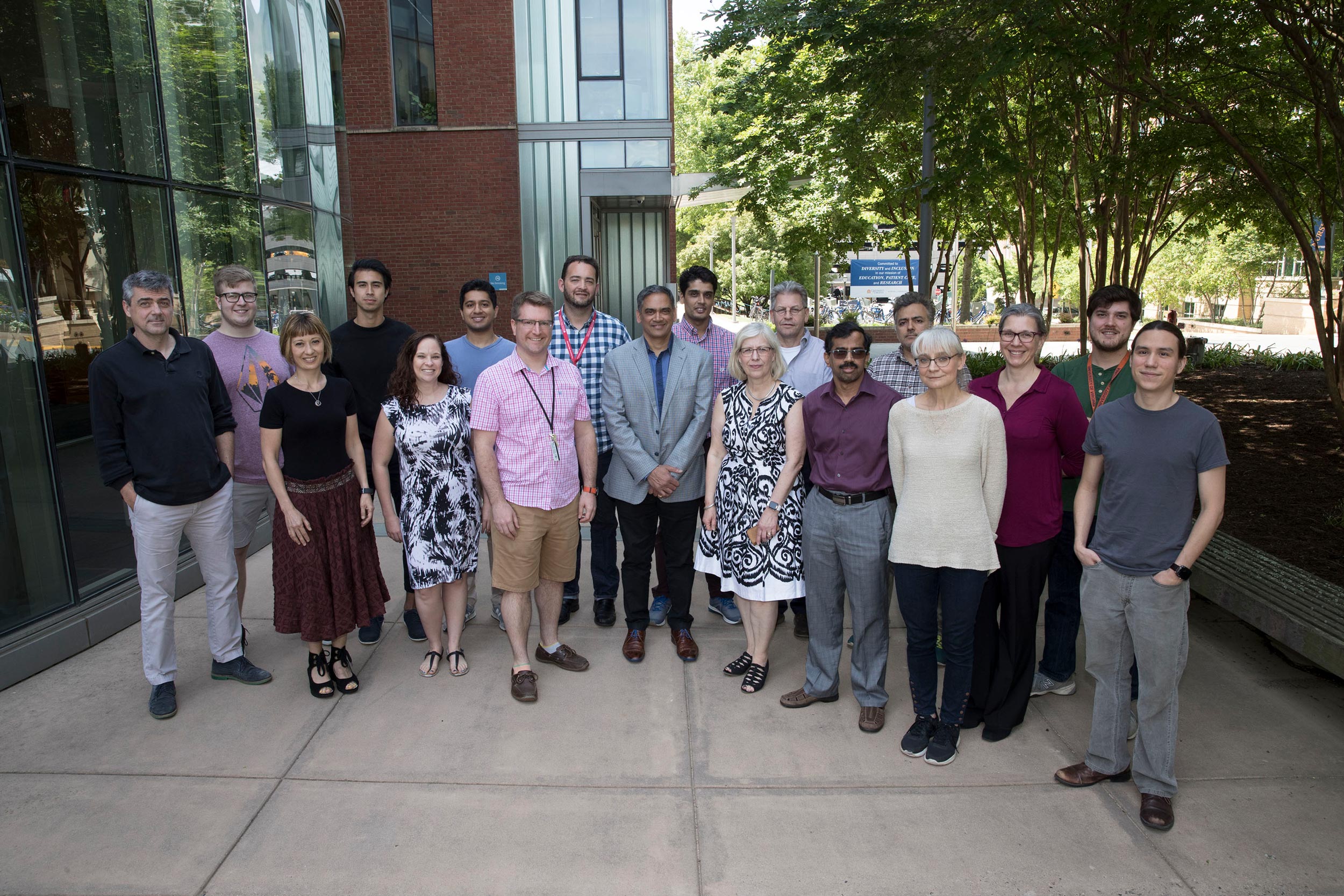 Kodi Ravichandran, center in grey jacket, stands for a group photo with his research group