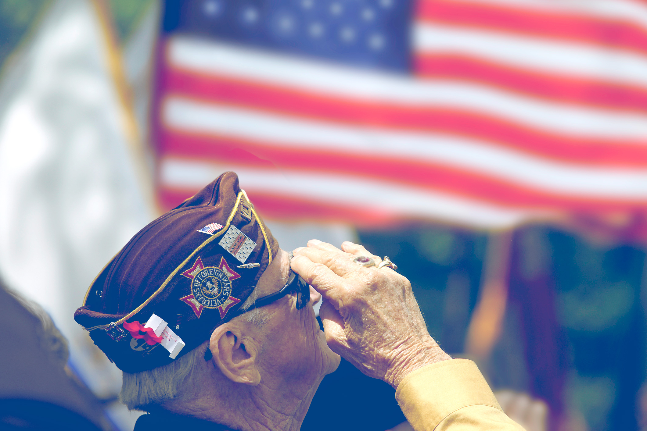 Veteran standing and saluting the flag