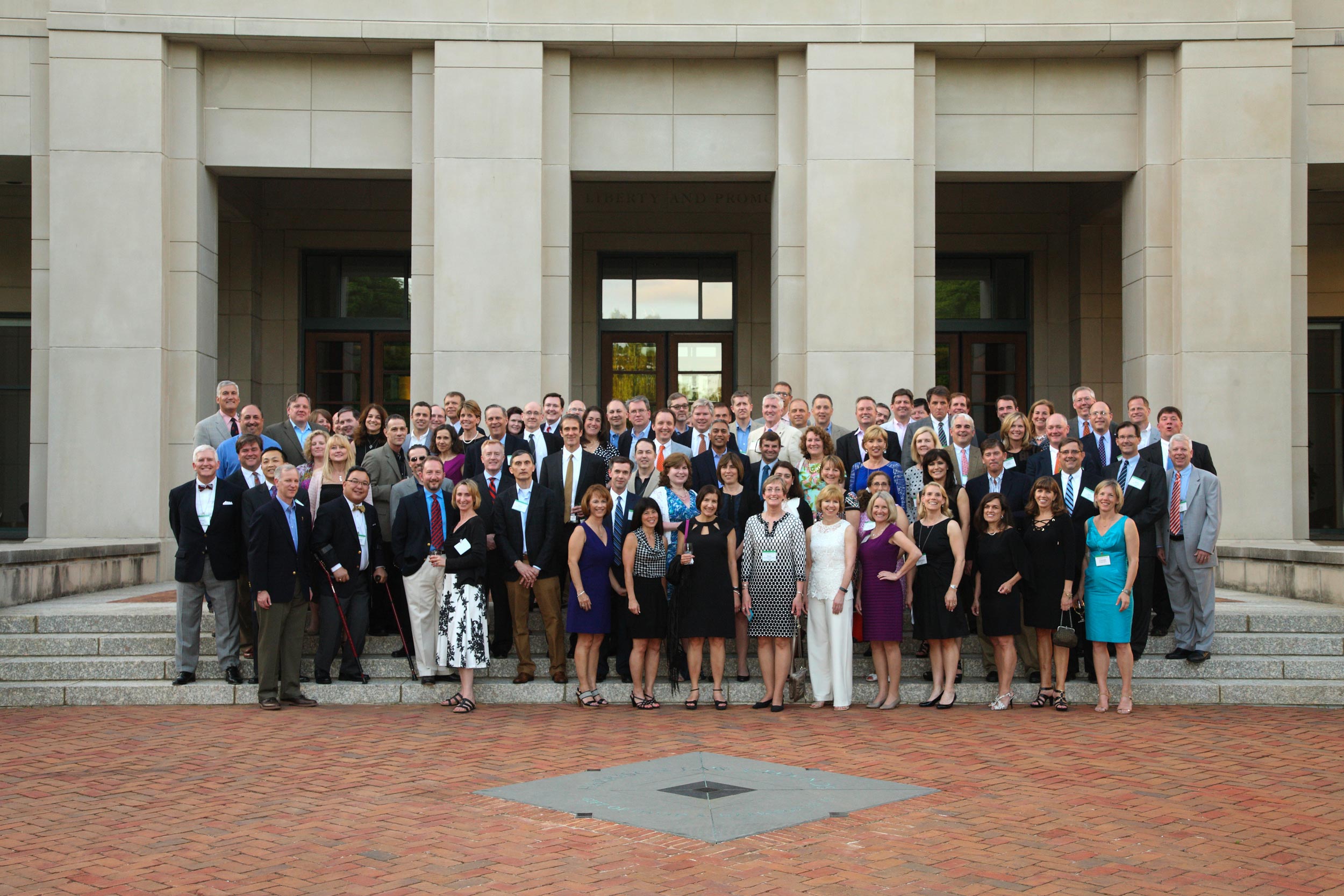 Class of 1990 law school stand on the steps of the School of Law for a group photo