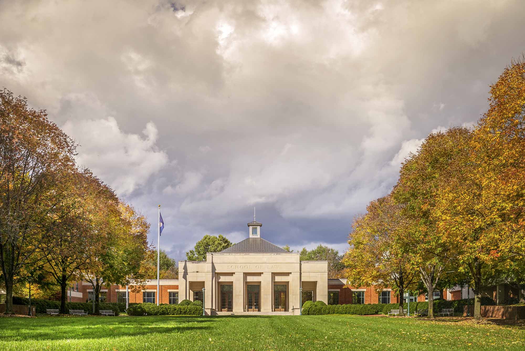 UVA Law school building's front entrance as storm clouds move in