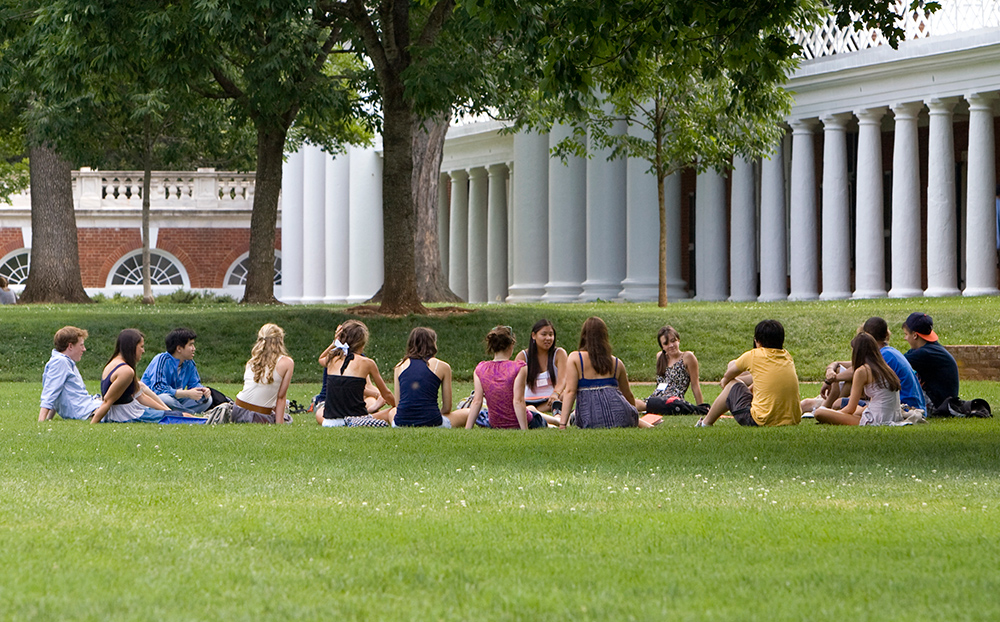 Students sitting in a circle on the lawn