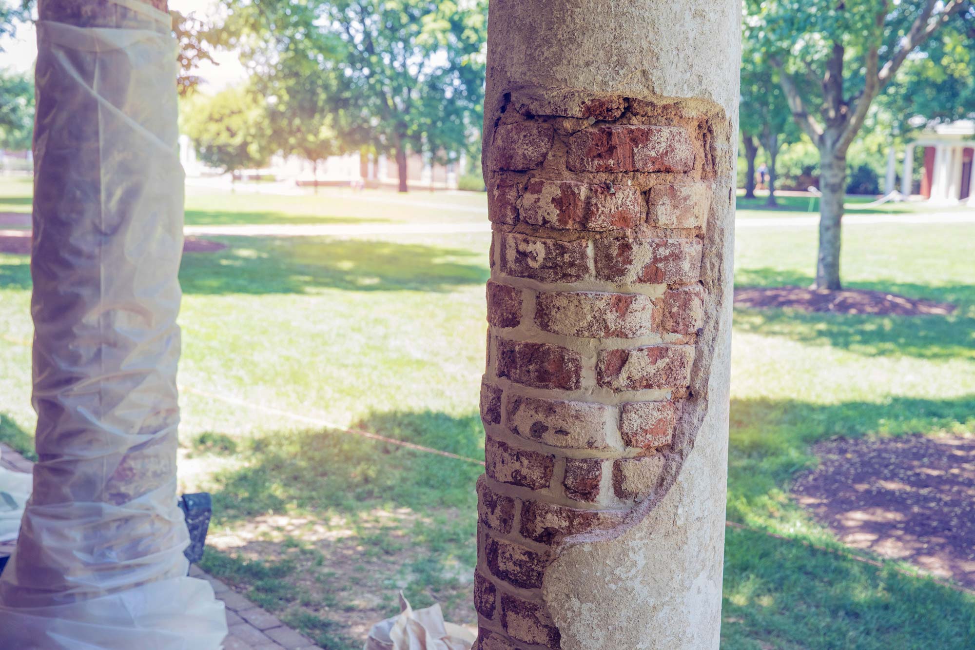 Cinderblock removed from a column exposing brick beneath