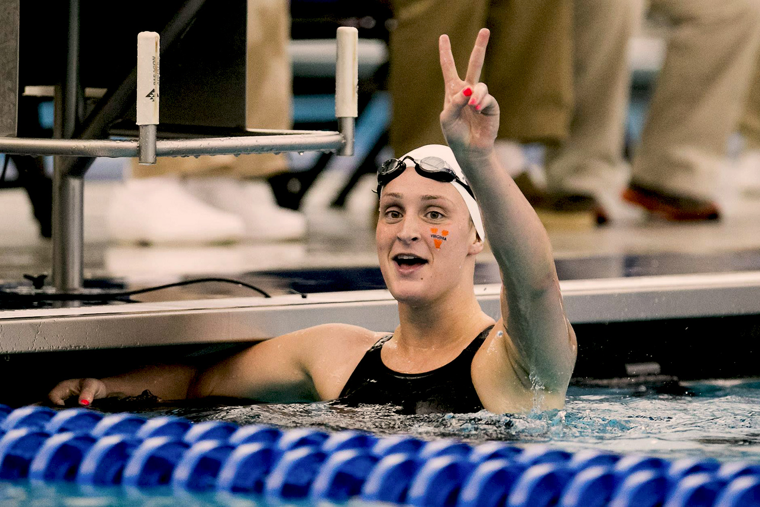 Leah Smith giving a peace sign to the crowd in the pool after a race
