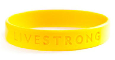 Yellow bracelet that reads: Live strong