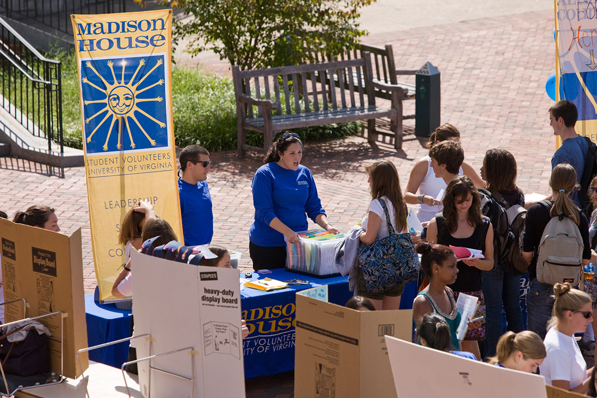 Madison House table with employees talking to students