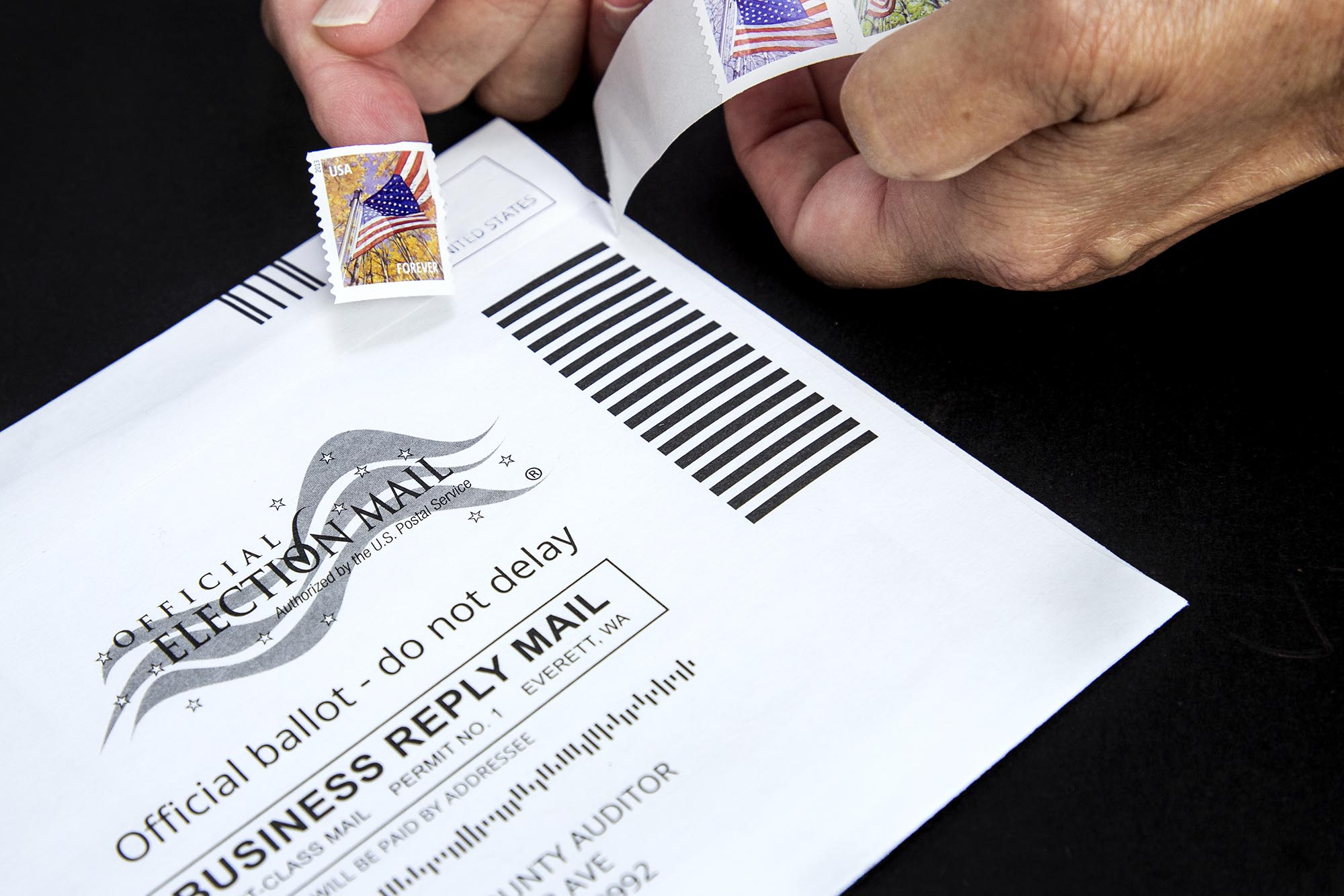 Person placing a stamp on a Ballot